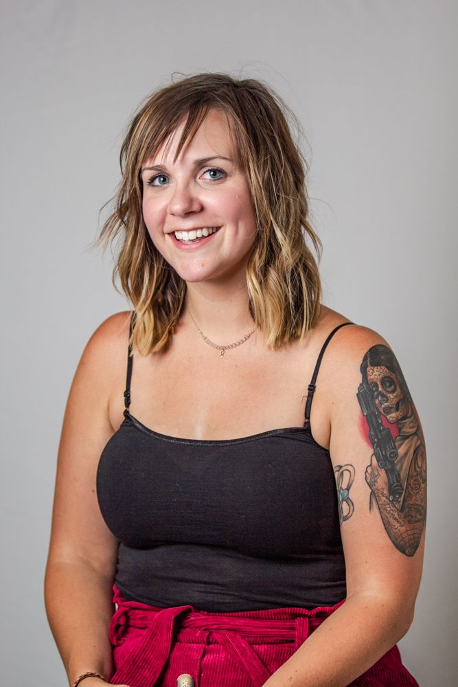 Studio portraits featuring casual poses in black tank top and red skirt against gray background.