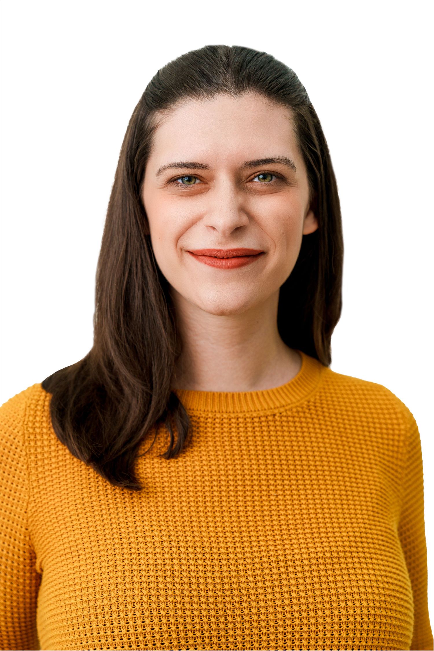 Studio portrait with warm lighting showing someone in a yellow textured sweater.