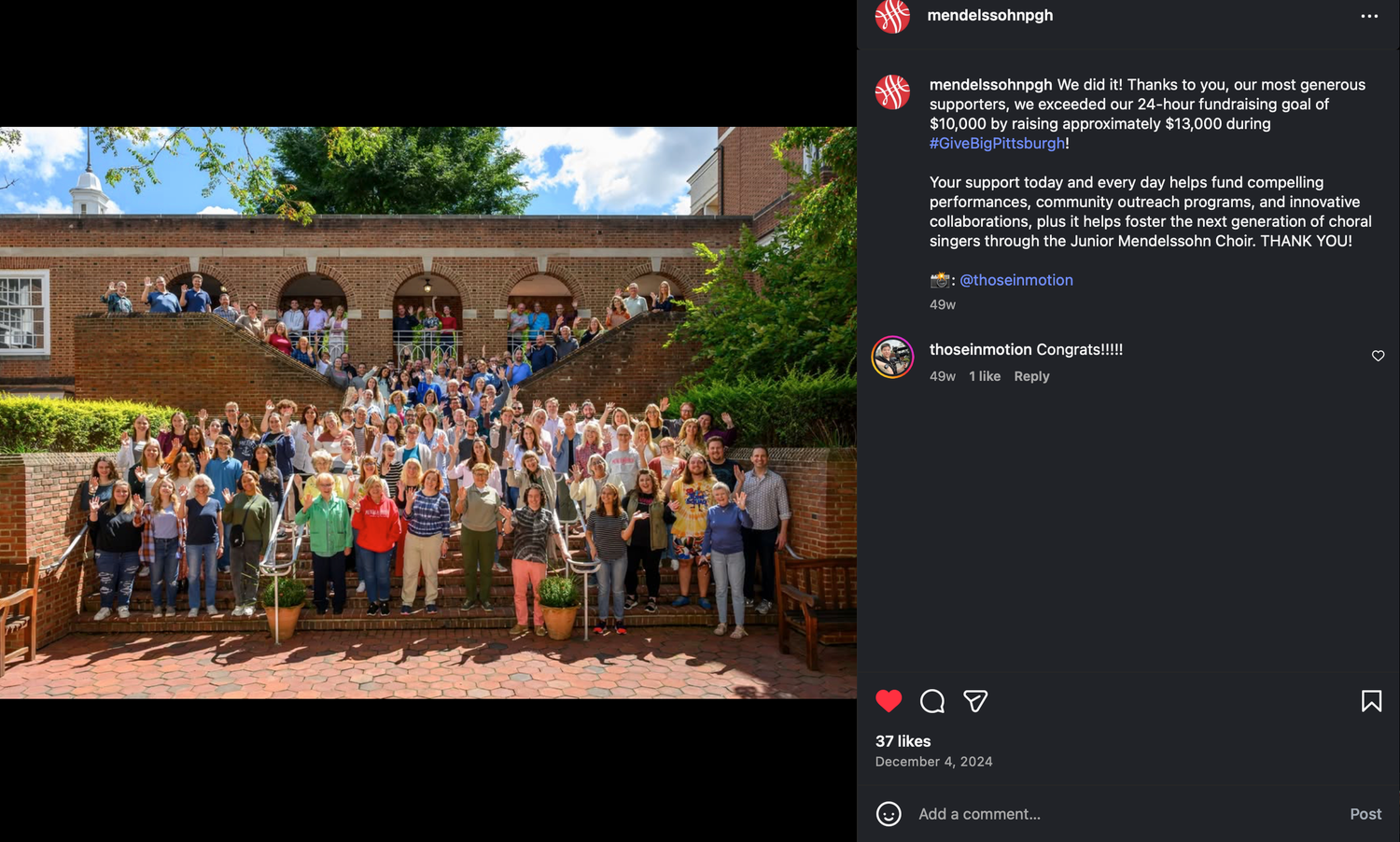 Large group photo of smiling supporters gathered outside a brick building, celebrating a fundraising milestone on social media.