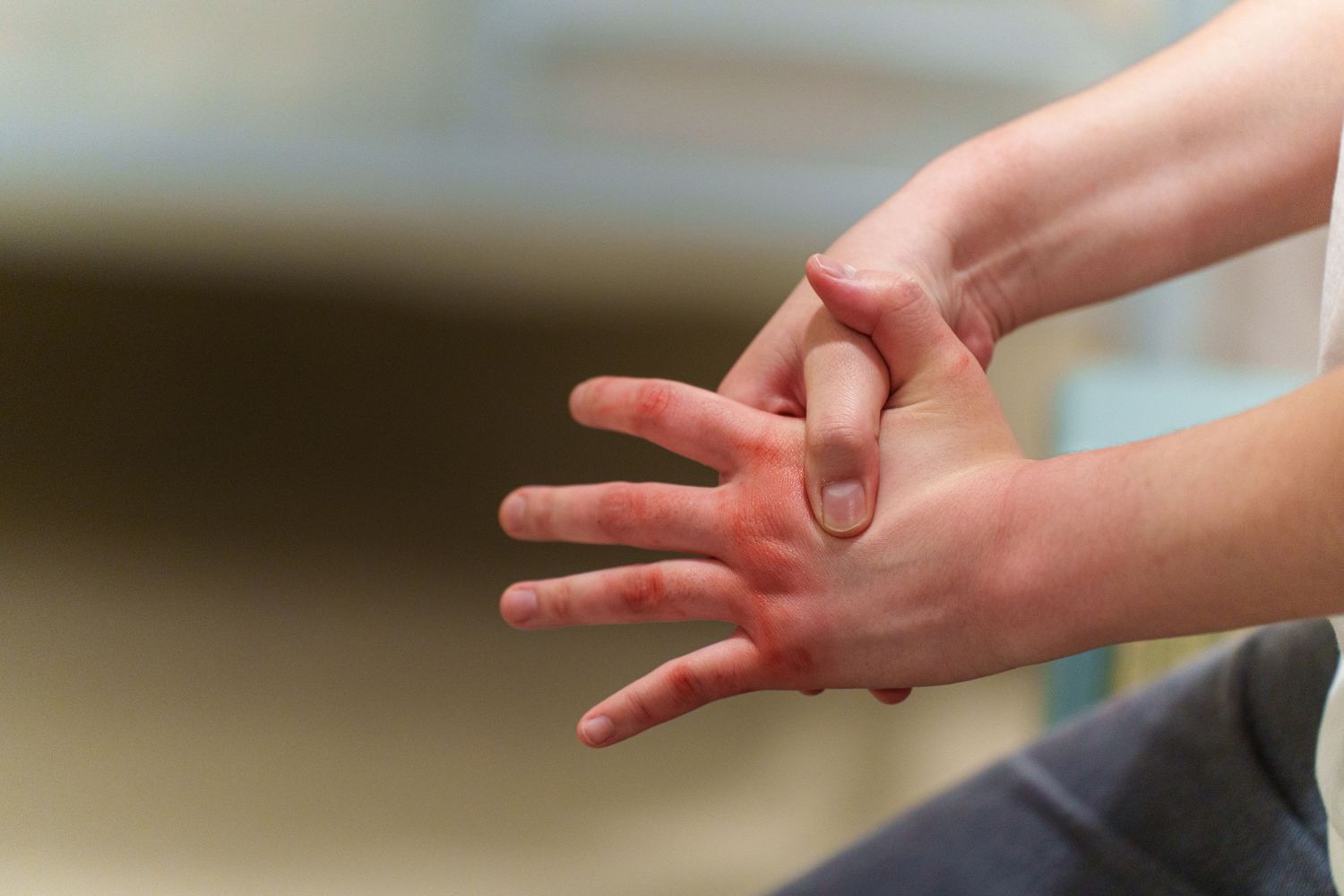 Hands gesturing and reaching across a table during what appears to be a conversation.