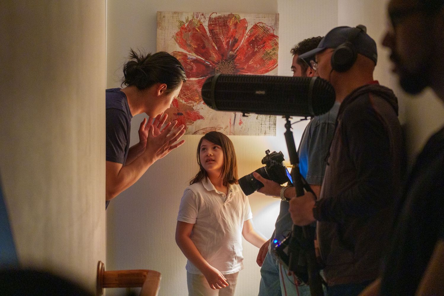 A behind-the-scenes photo shoot setup with camera equipment and lighting visible.