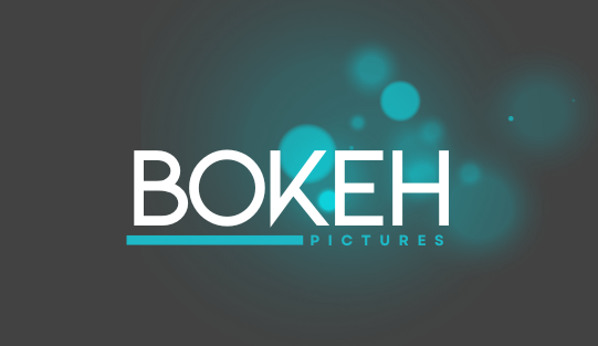 A series of blurred blue bokeh light effects and text overlays against a dark background.