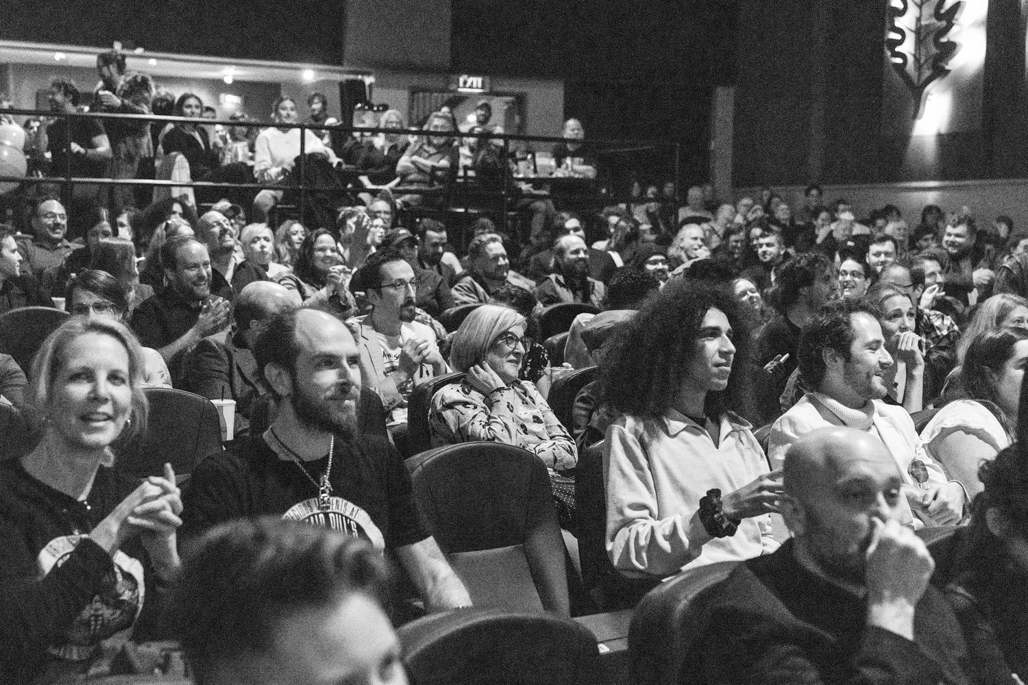 Audience members fill theater seats during an awards ceremony or film screening event.