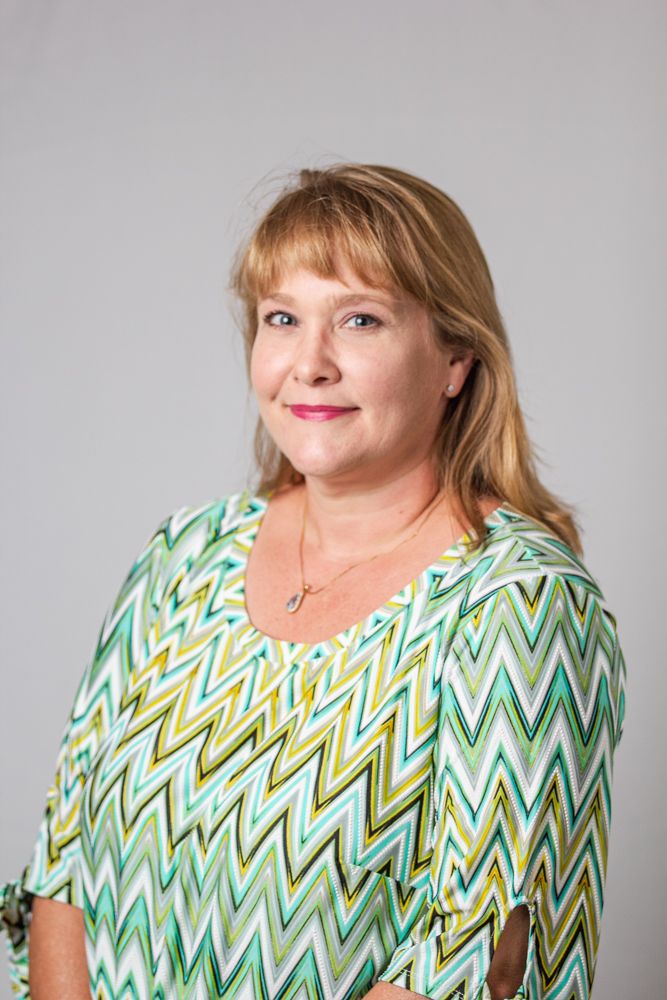 A series of photos showing someone wearing a green and yellow chevron patterned top against a gray background.