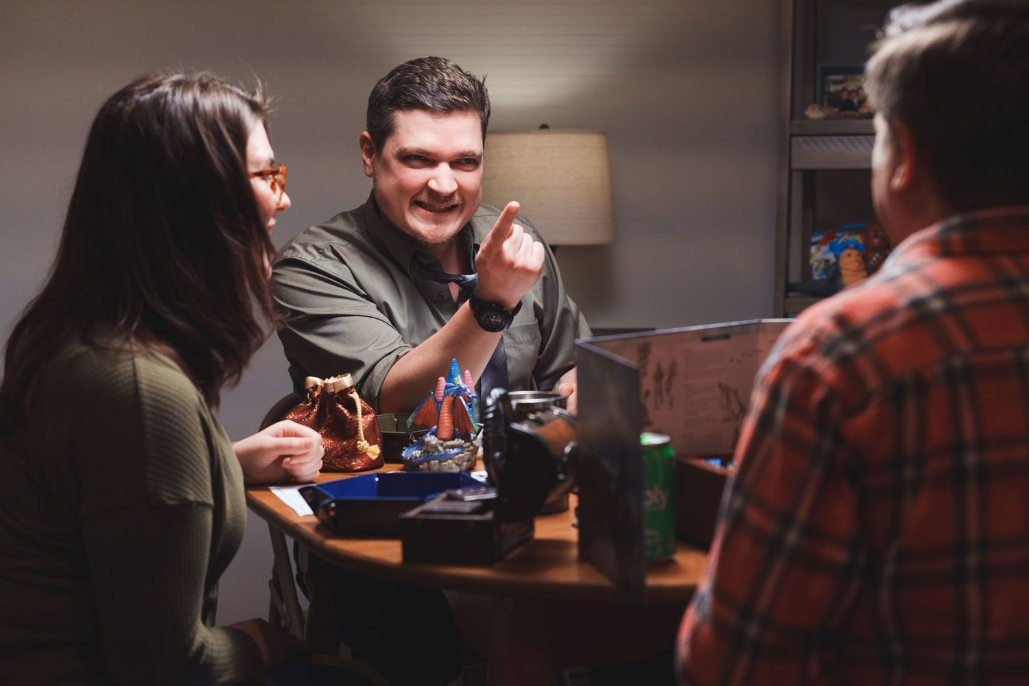 Group of people engaged in animated conversation around a table.