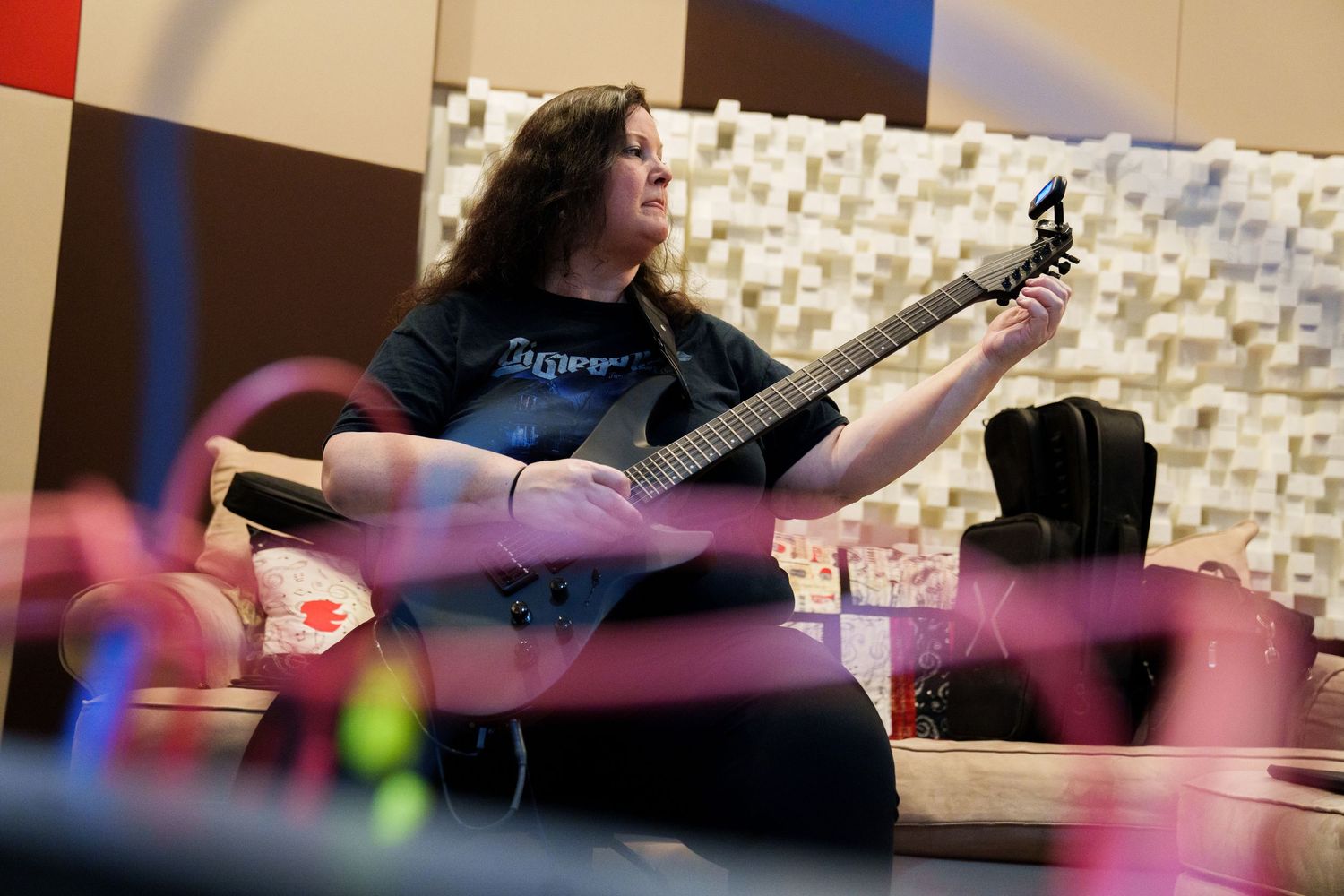 Studio recording session with colorful lighting and musical instruments.