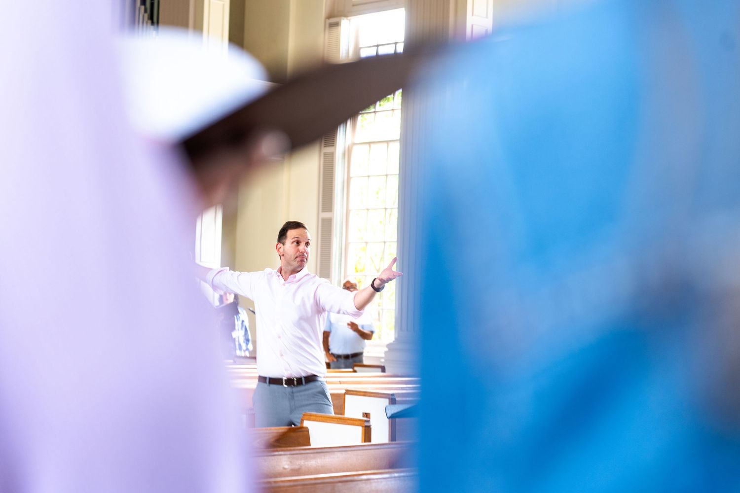A sequence of blurry blue and white motion-captured images showing someone moving through a bright interior space.