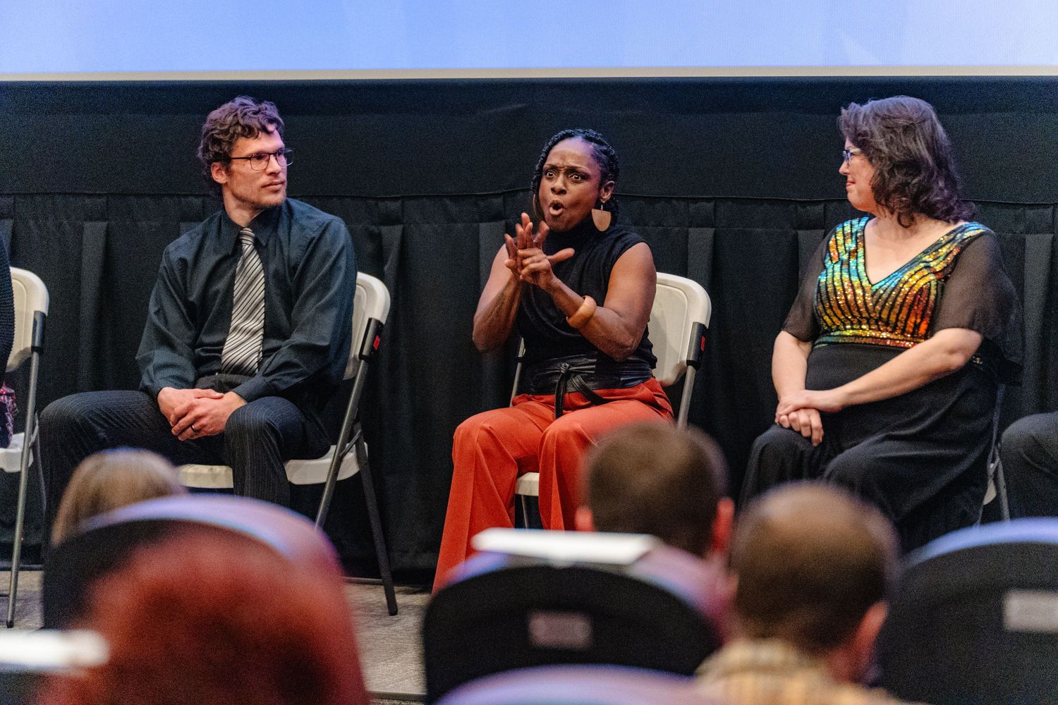 A panel discussion event shows speakers seated on stage engaging in conversation at a conference or forum.