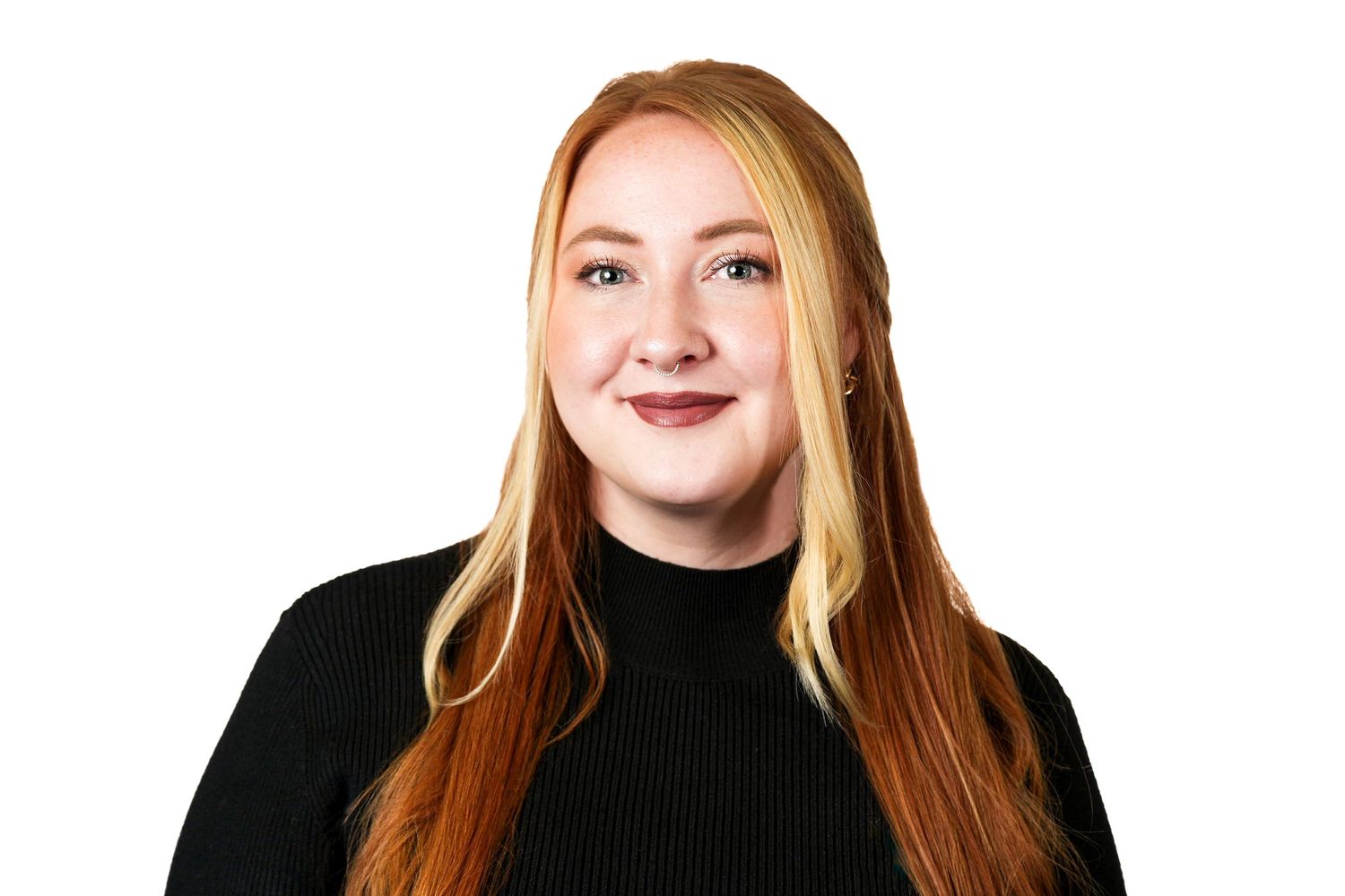 Portrait of person wearing black sweater against white background.