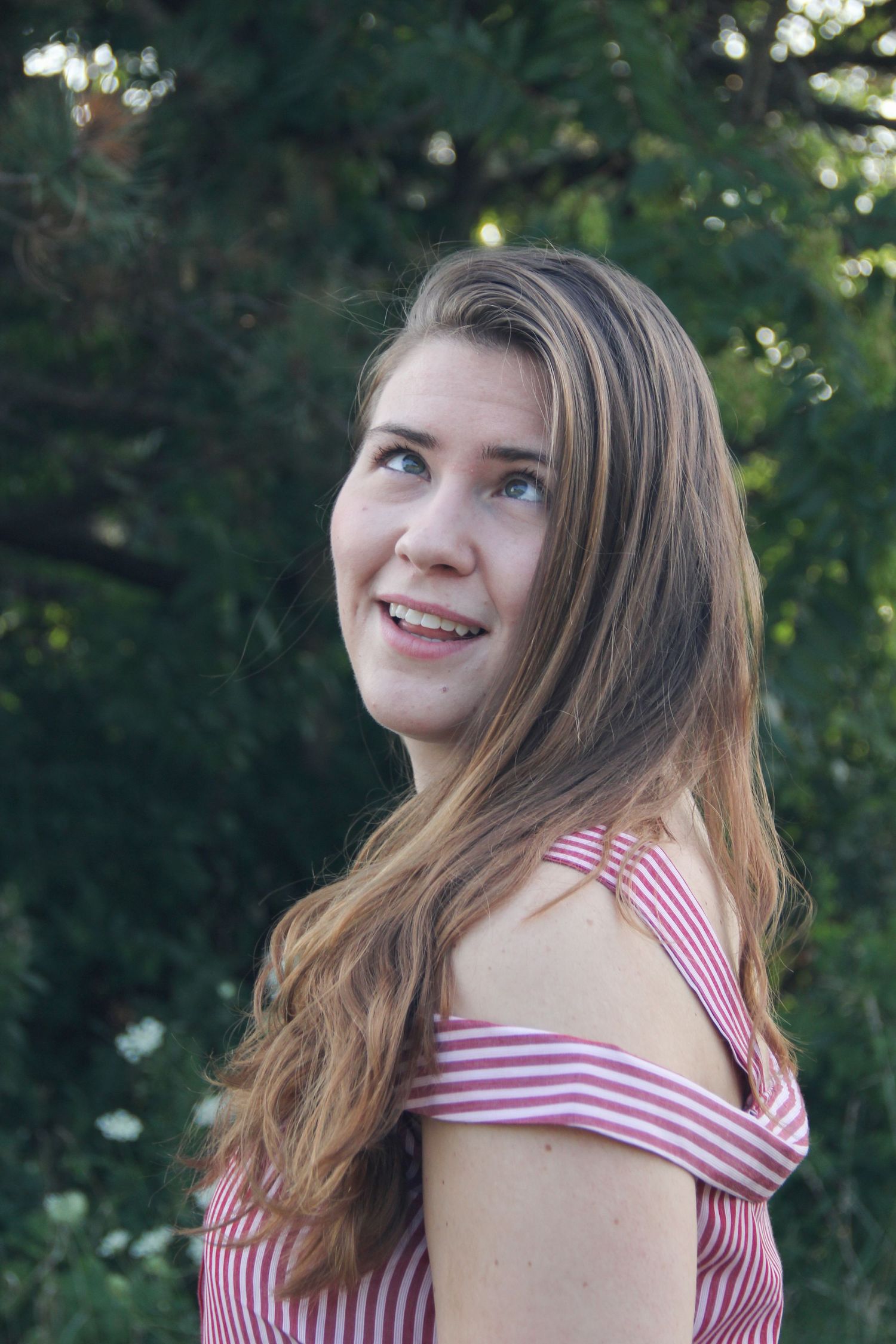 Candid outdoor portrait wearing red and white striped summer dress.