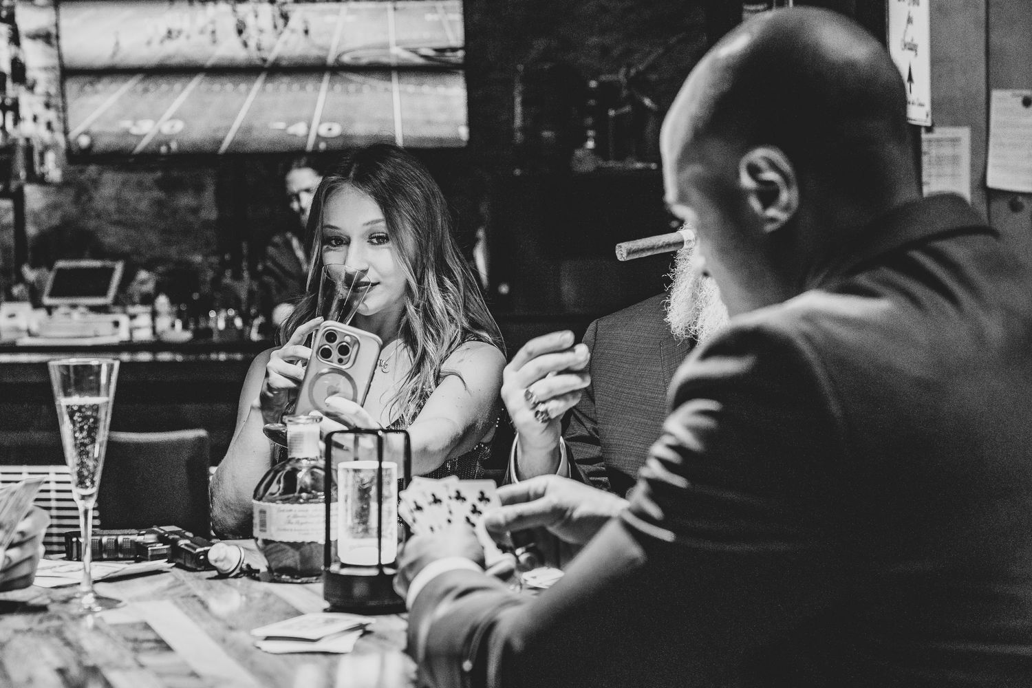 Two people dining at a restaurant table in black and white, engaged in casual conversation.