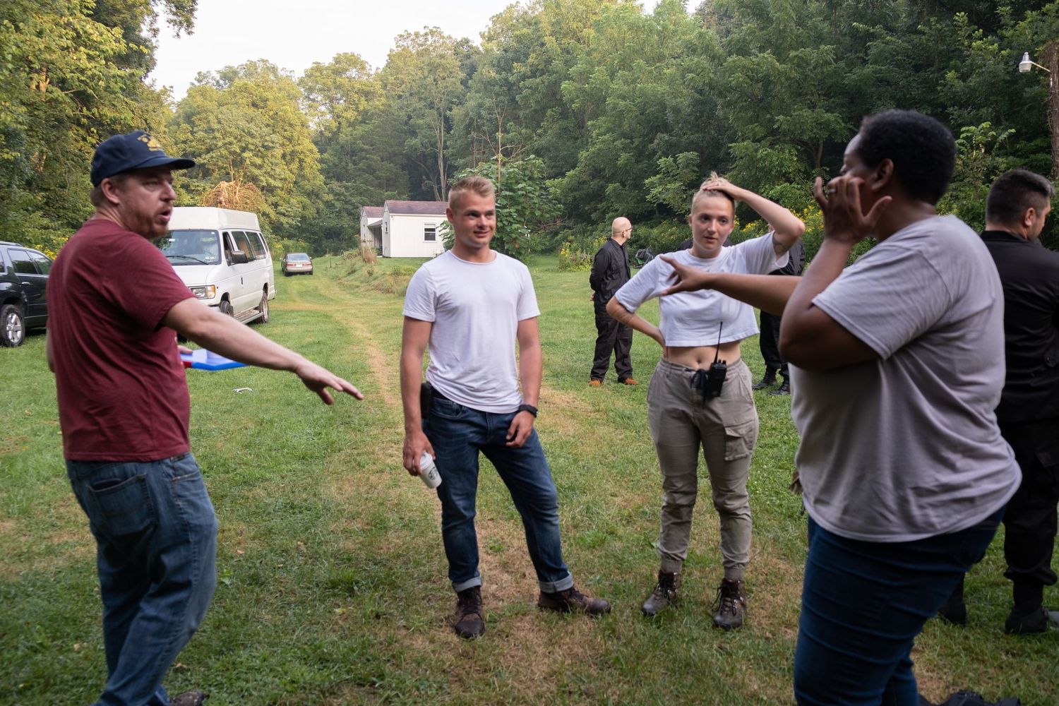 Group of people having discussion outdoors in casual setting.