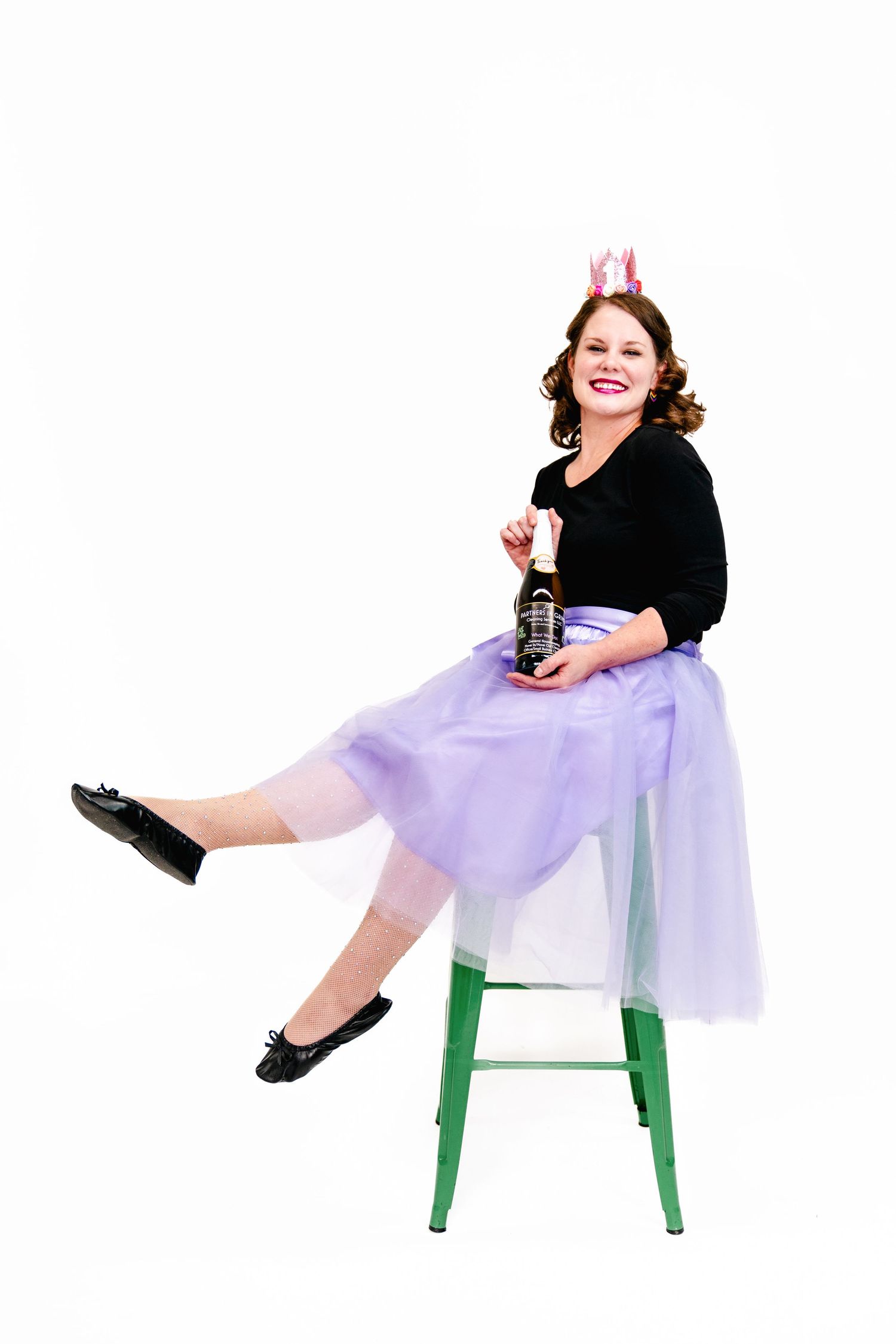 Retro-inspired portrait on green stool wearing purple tulle skirt and crown.