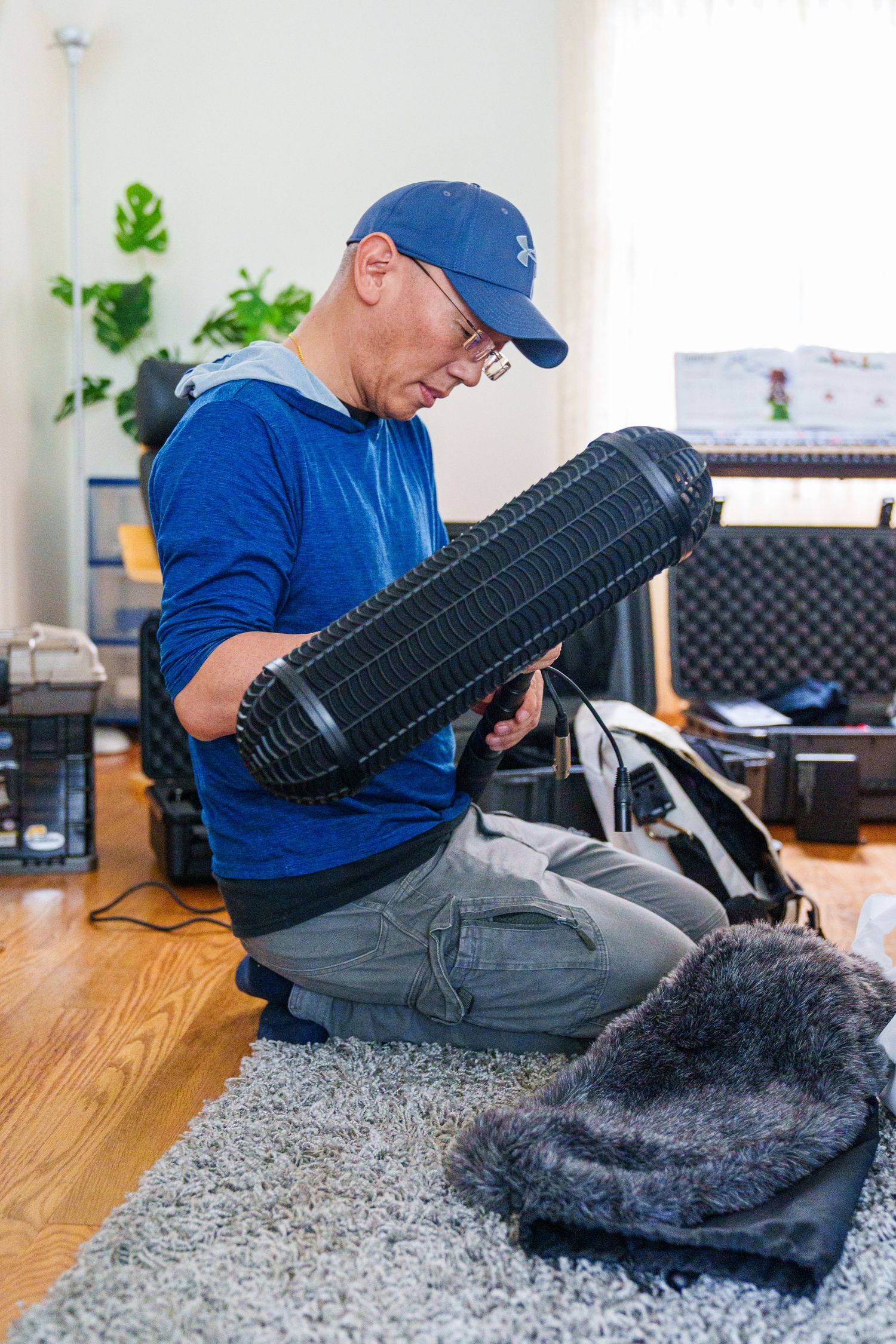 Someone in blue works on fixing a tire on a carpeted floor with various tools.