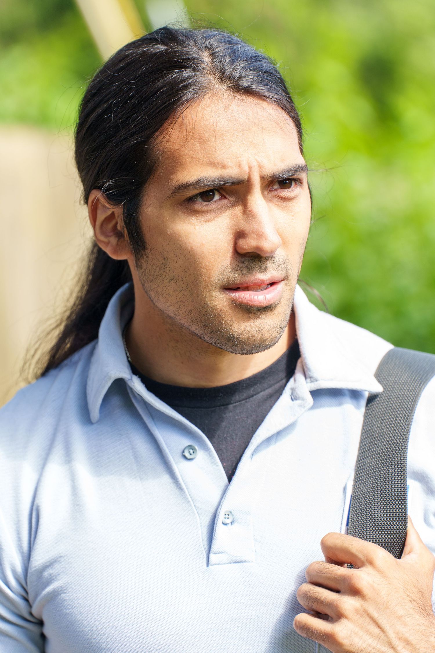 Close-up profile shots of someone wearing a white polo shirt outdoors.