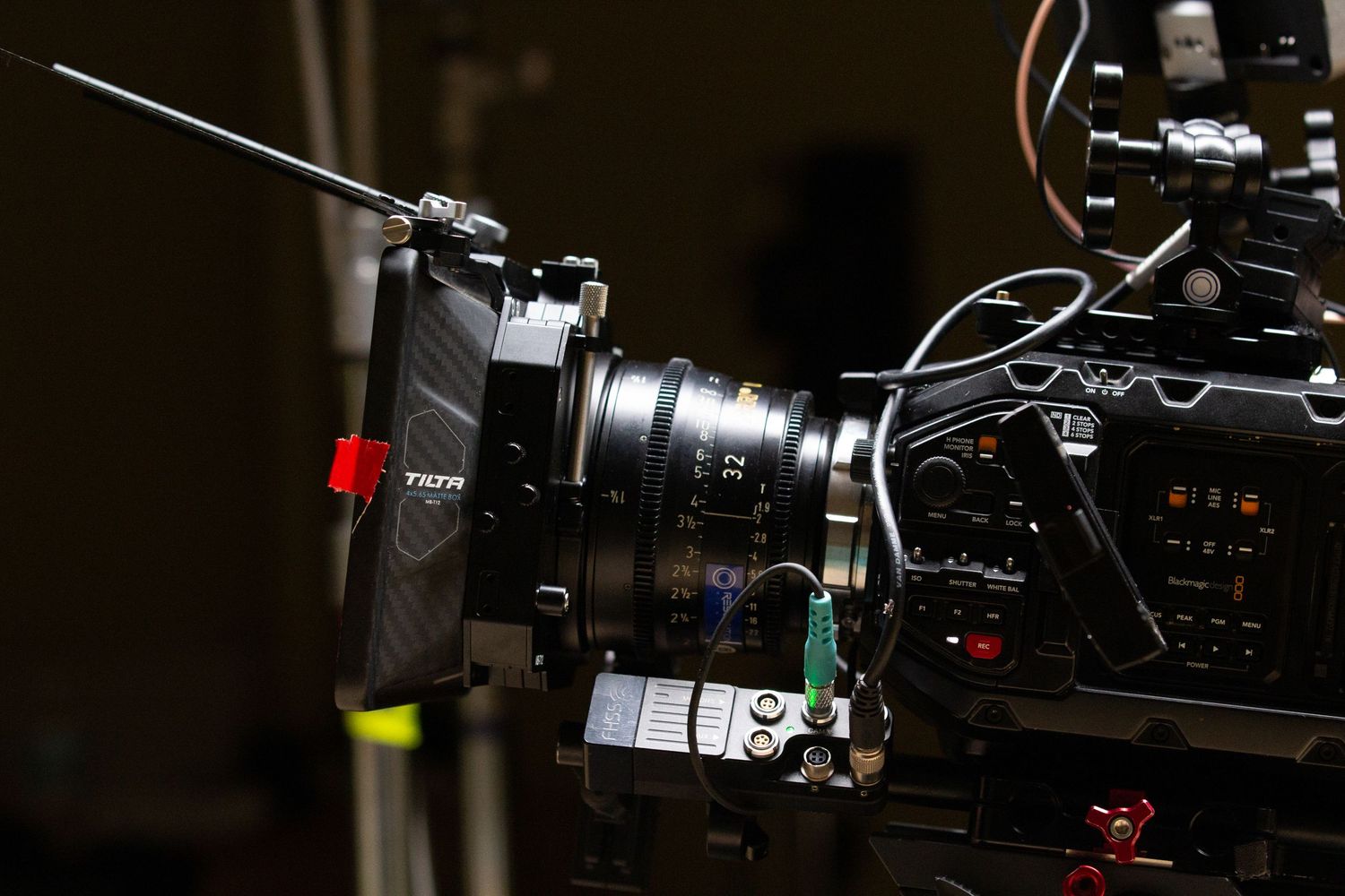 Close-up of a professional Tilta cinema camera rig with lens and accessories on a film set.