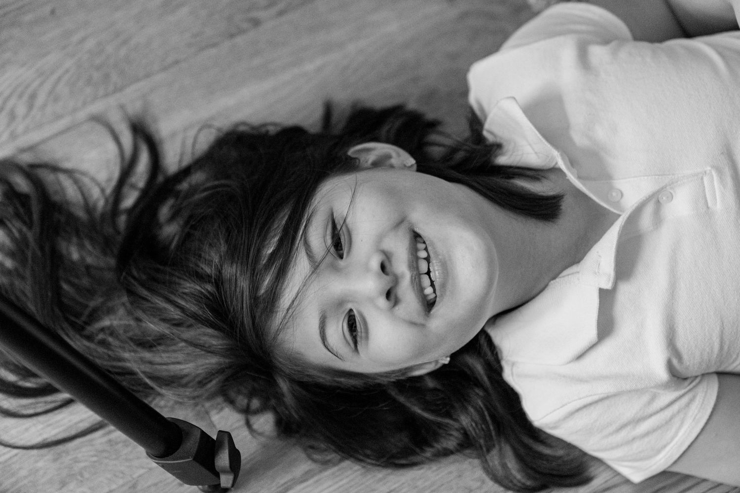 A black and white artistic portrait shot against a light background.
