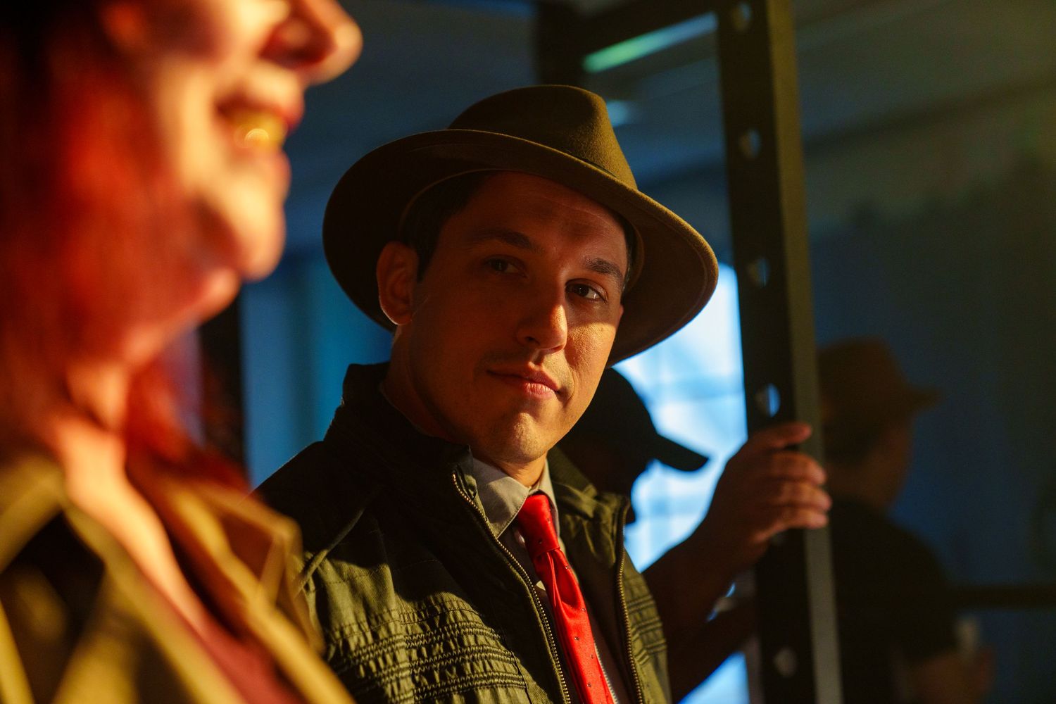 Cinematic shot showing figures in shadow with dramatic side lighting.
