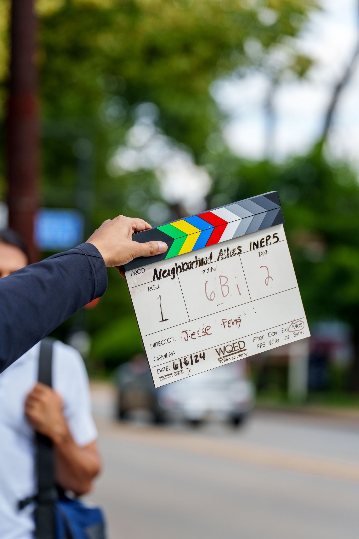 Movie slate board being held up during an outdoor film production shoot.