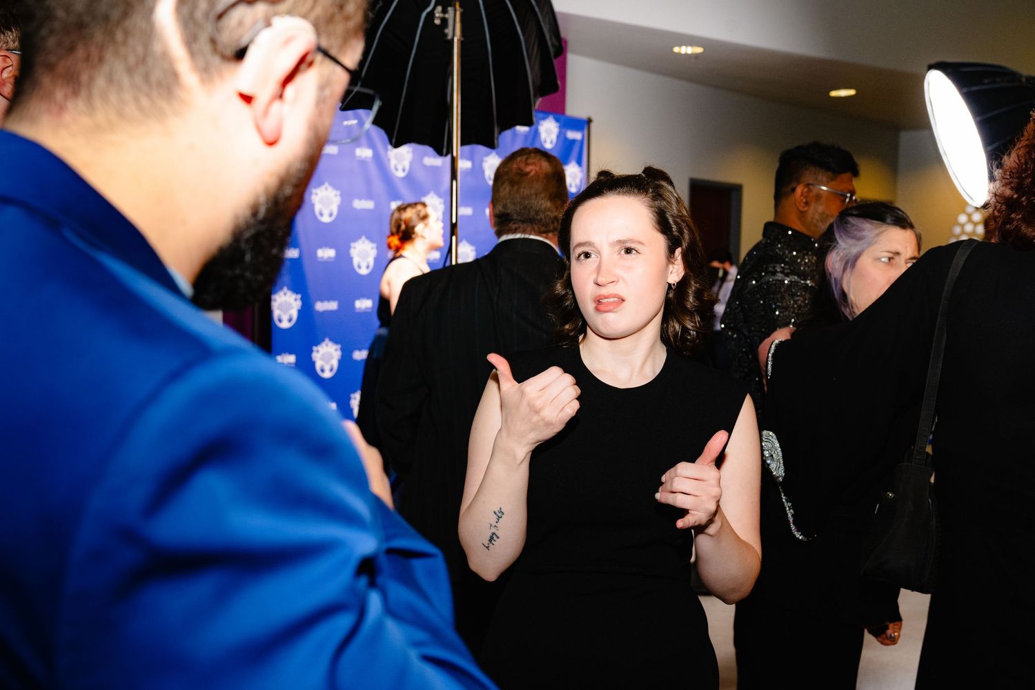 A series of candid photos showing people interacting and talking at what appears to be a professional networking event.