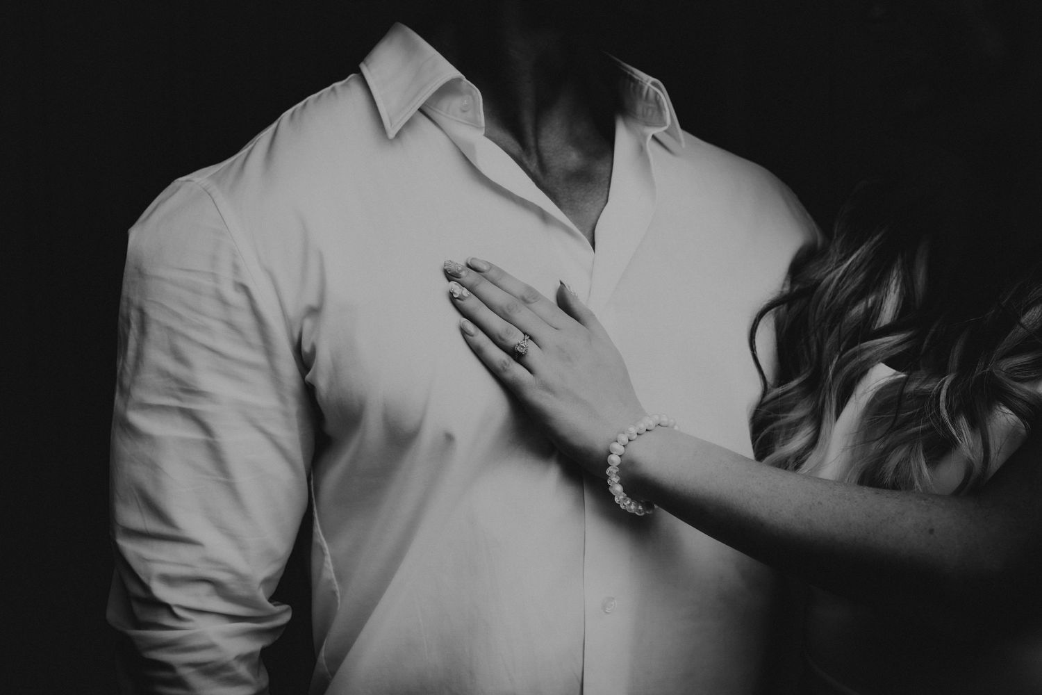 couple holding hands looking at eachother during their engagement session in downtown lethbridge alberta