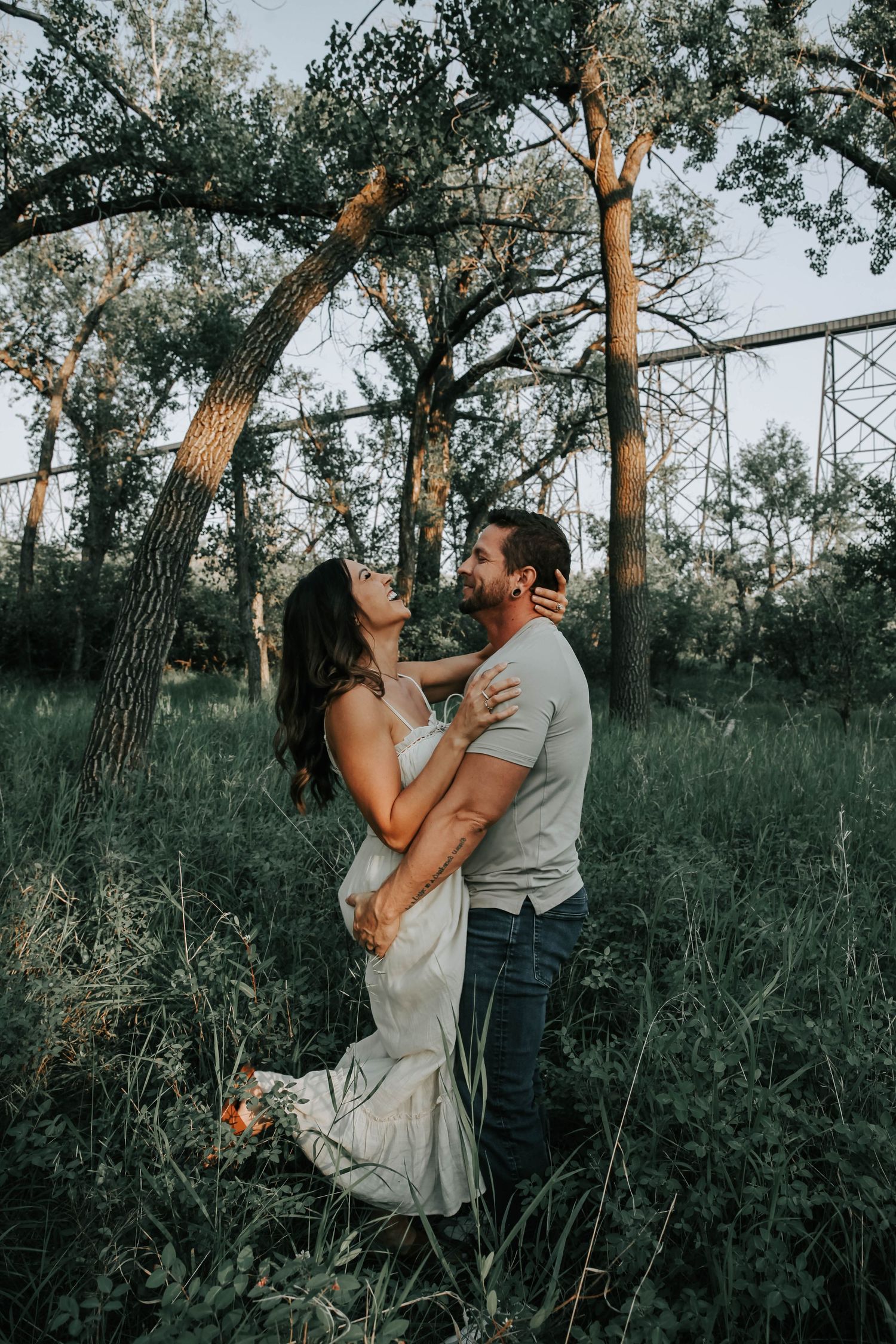 couple holding hands looking at eachother during their engagement session in downtown lethbridge alberta
