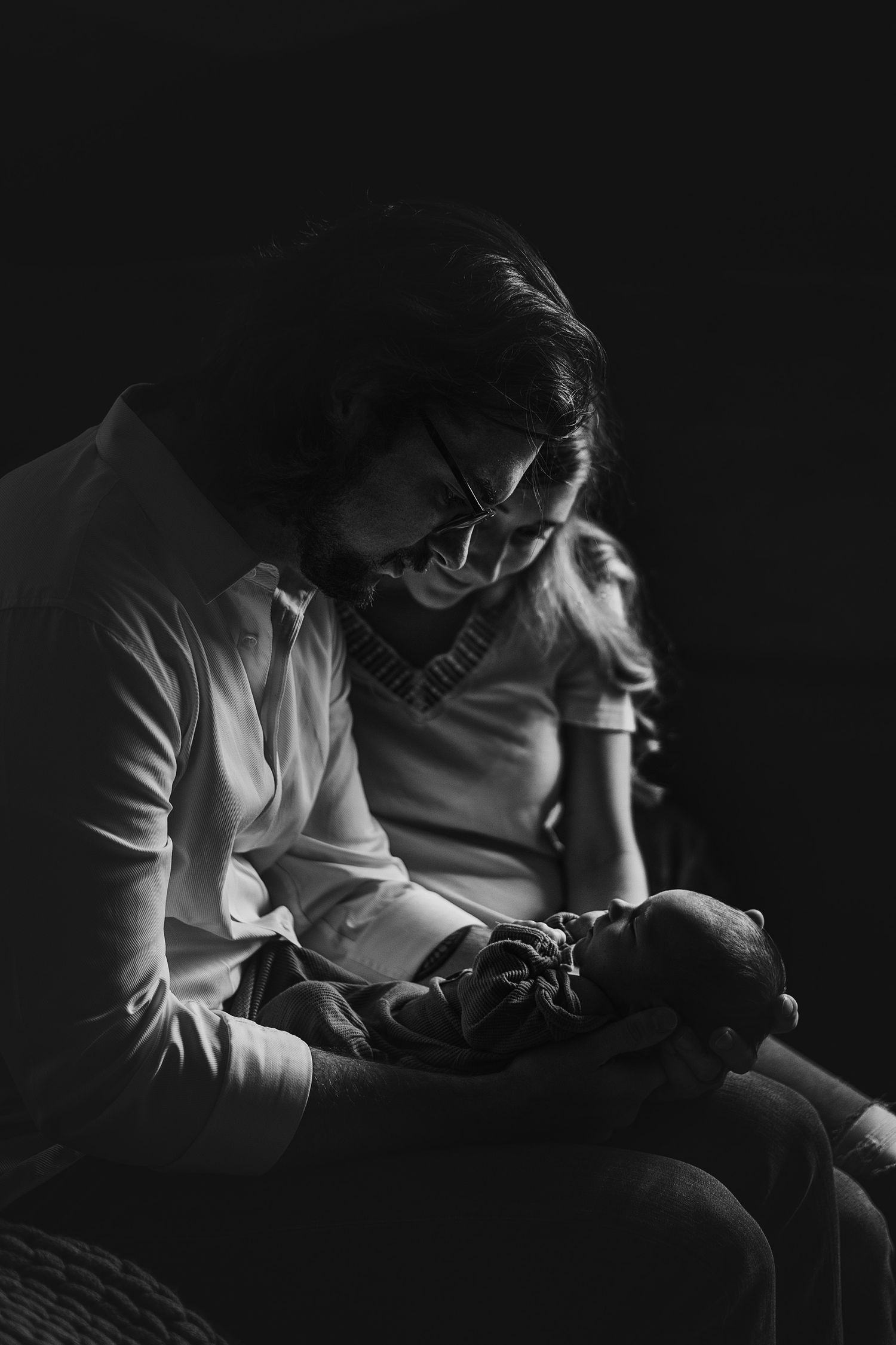 A dramatic black and white photo sequence showing someone performing dental work in low light conditions.