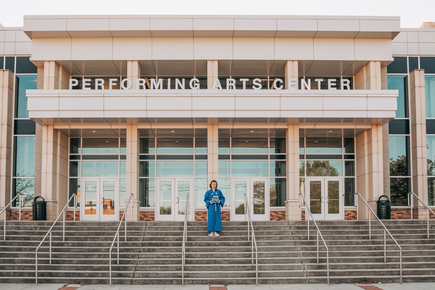 Performing arts center exterior with wide stairs and modern architectural design.