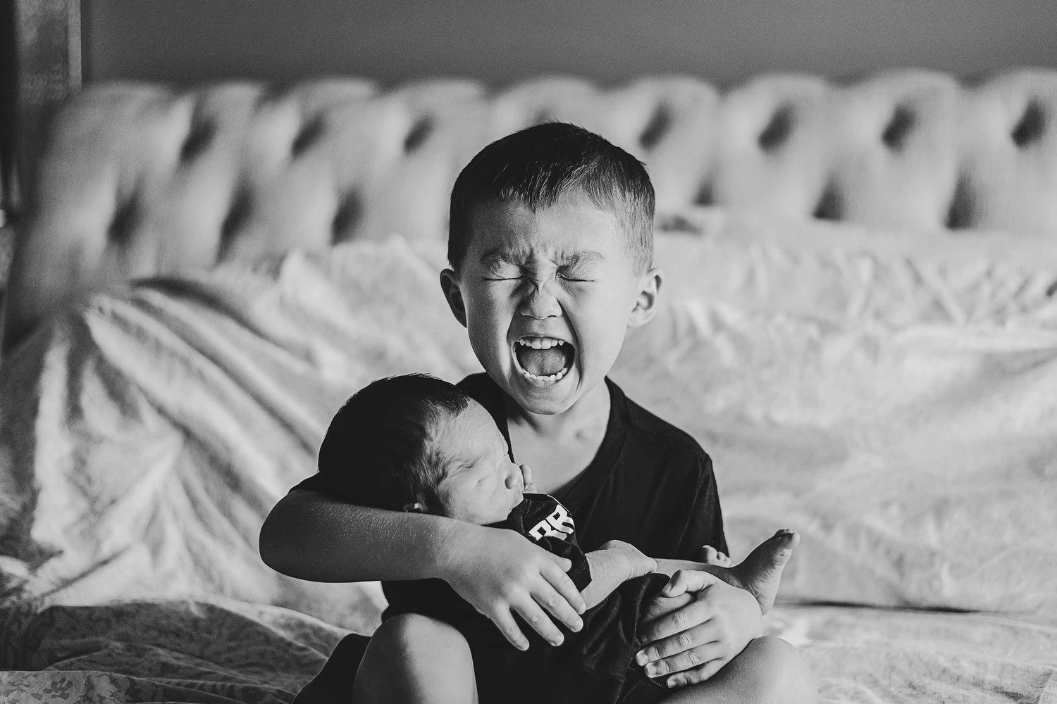 A series of black and white photos showing joyful expressions and intimate moments between two people on a bed.