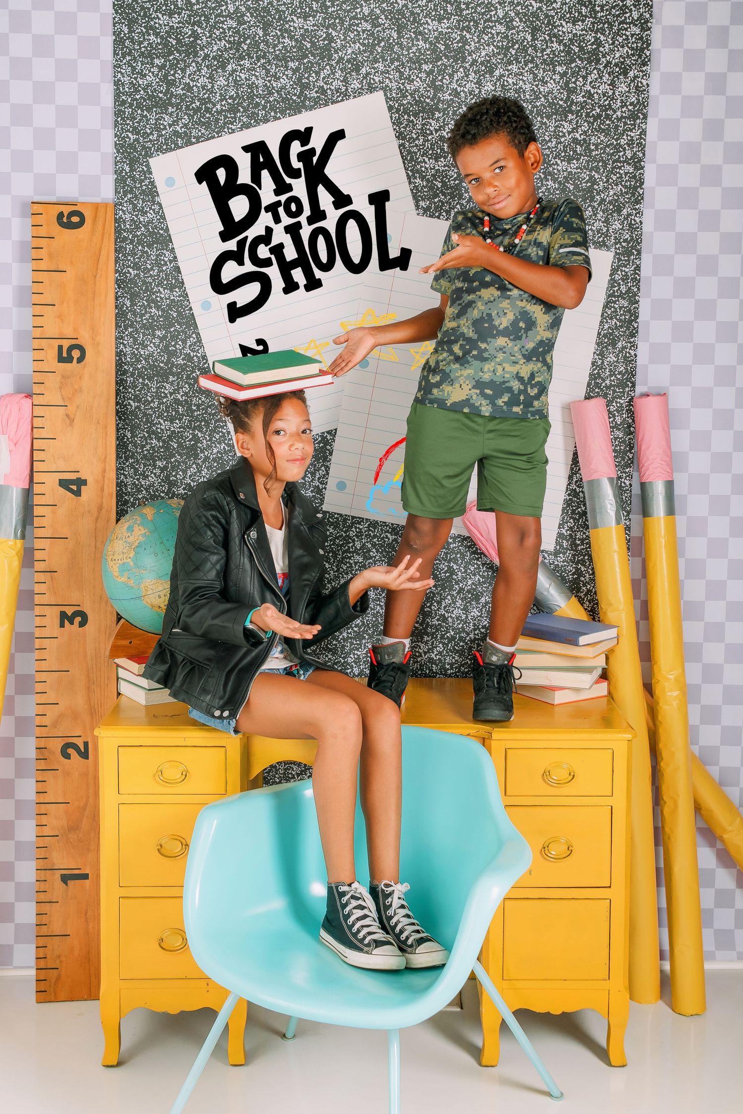 Back to school themed photo series with yellow filing cabinets and teal chair showing school supplies and books.