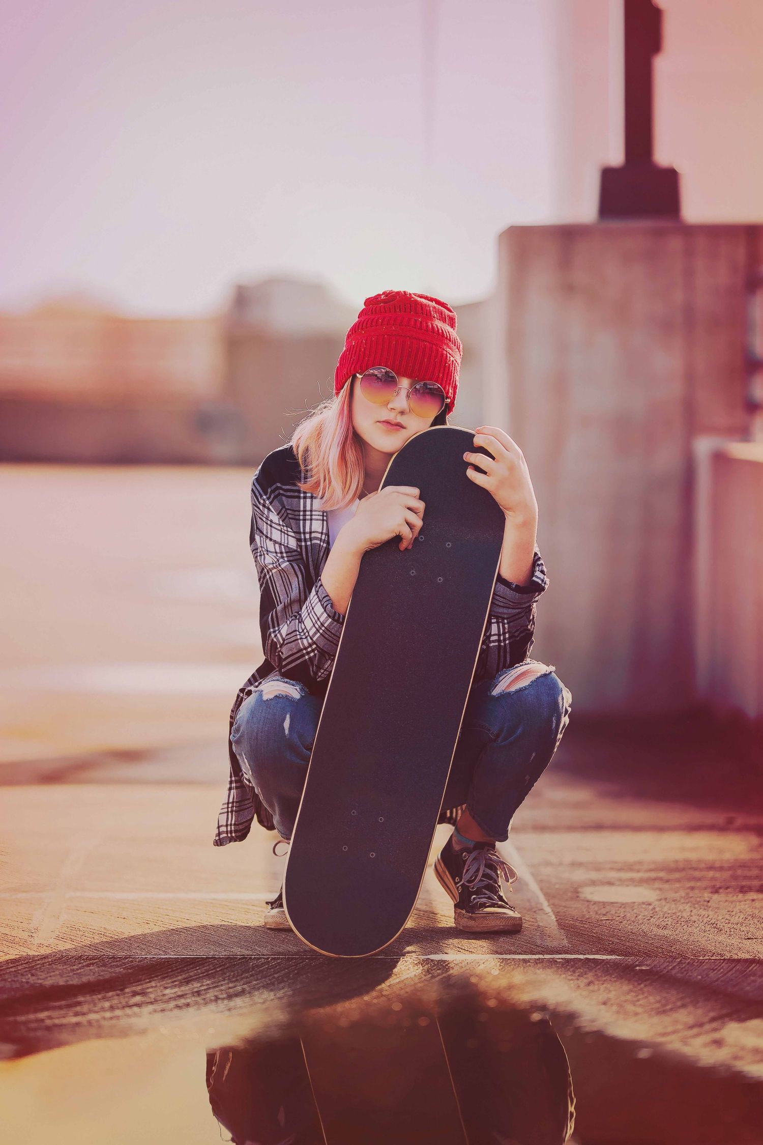 A series of photos showing someone sitting with a skateboard in warm sunlit tones.