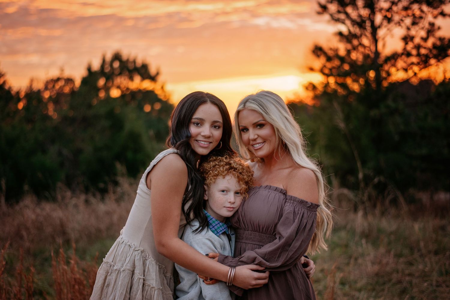 Sunset portrait session in field with warm golden lighting.