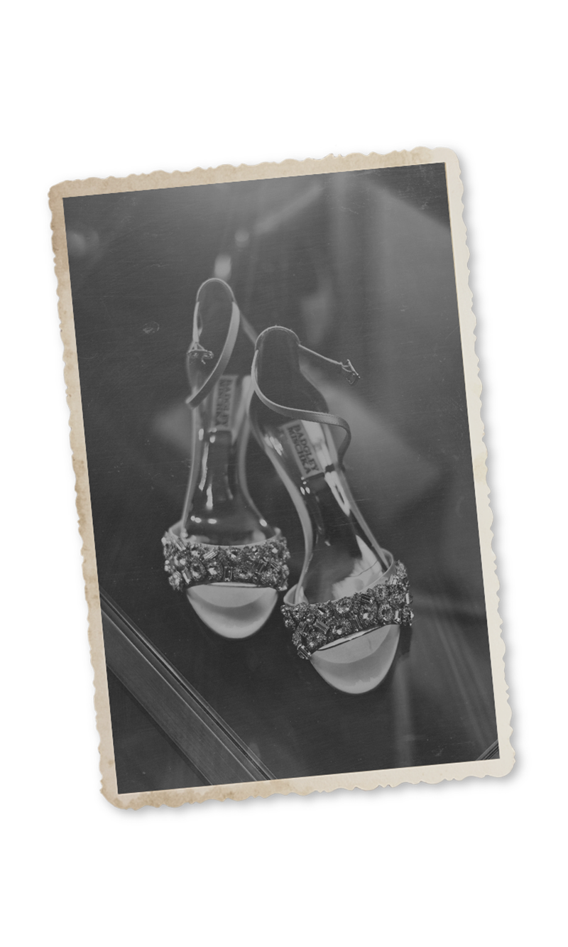 Vintage black and white photo of elegant jeweled bridal heels with ankle straps and crystal embellishments.