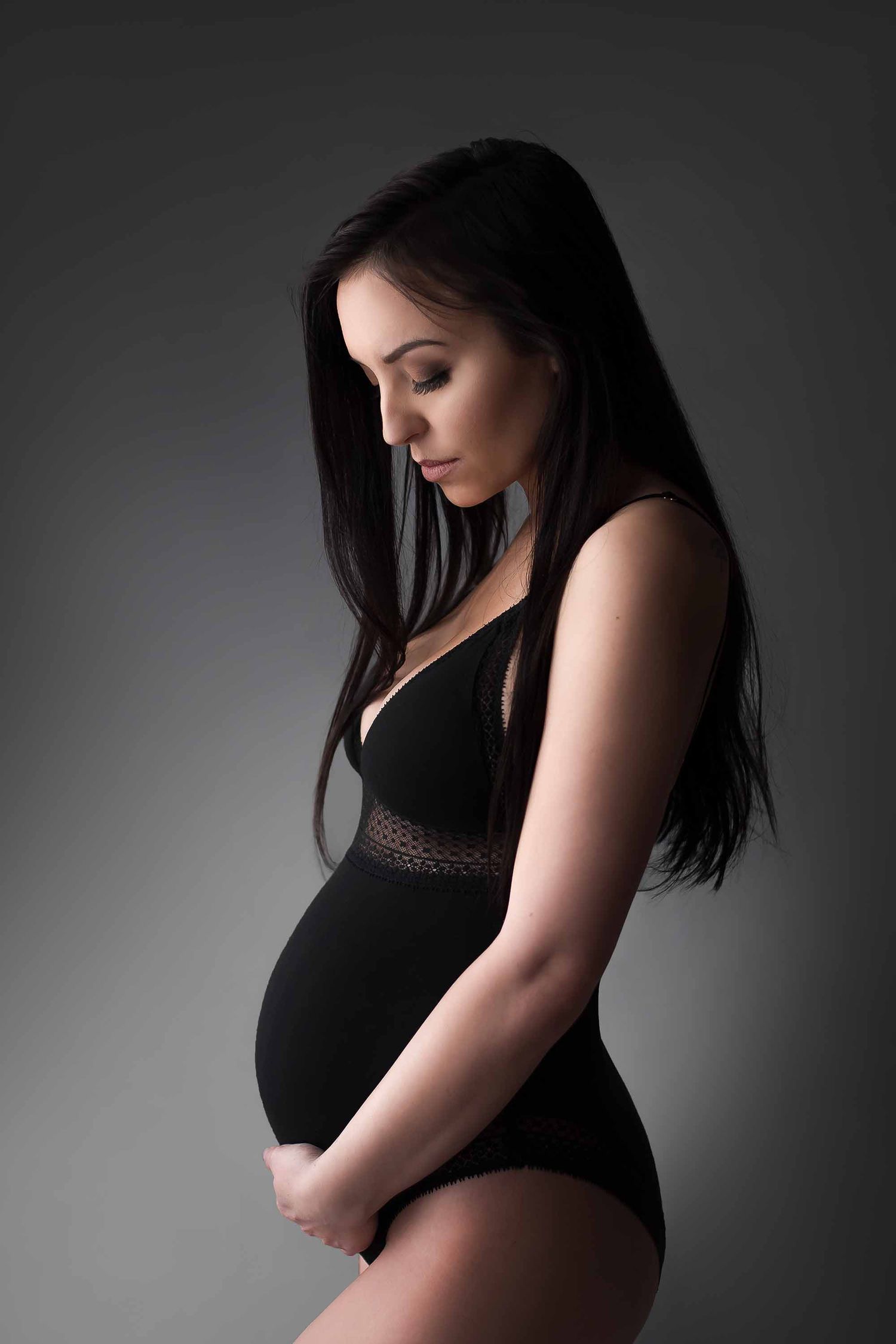 A silhouetted maternity photo series shows an expectant mother in black against a gray background.