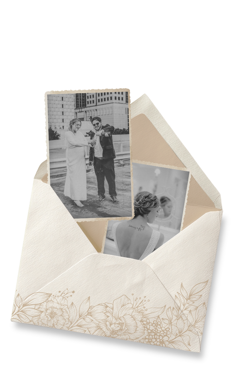 Elegant wedding envelope with floral design containing black and white photos of a bride and groom.