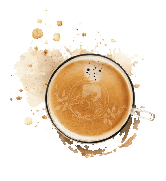Overhead view of a creamy latte in a glass cup with latte art, surrounded by coffee splashes on white background.
