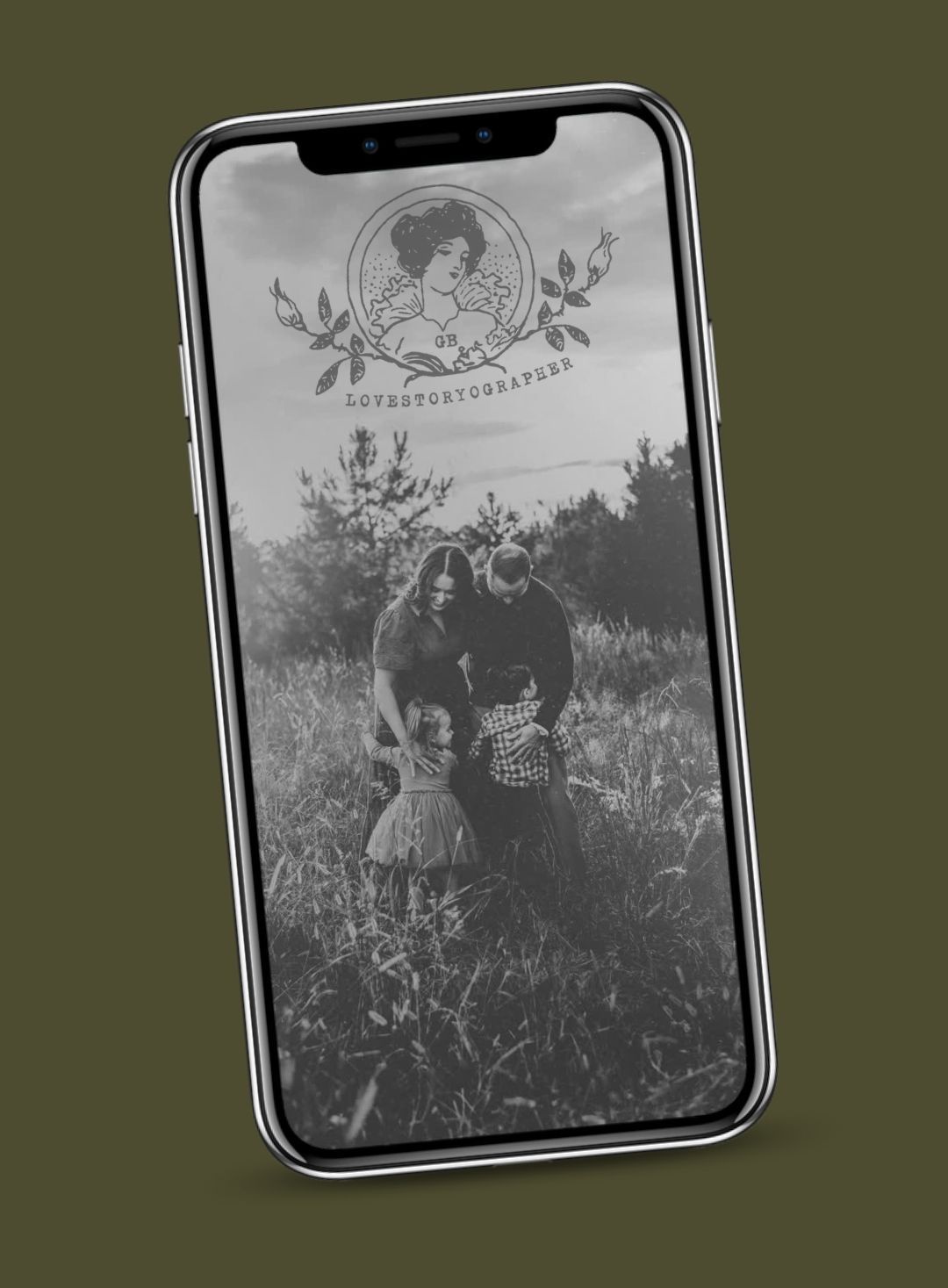 A smartphone displaying a black-and-white family photo in a field, with a vintage LoveStoryGraphers logo overlay.