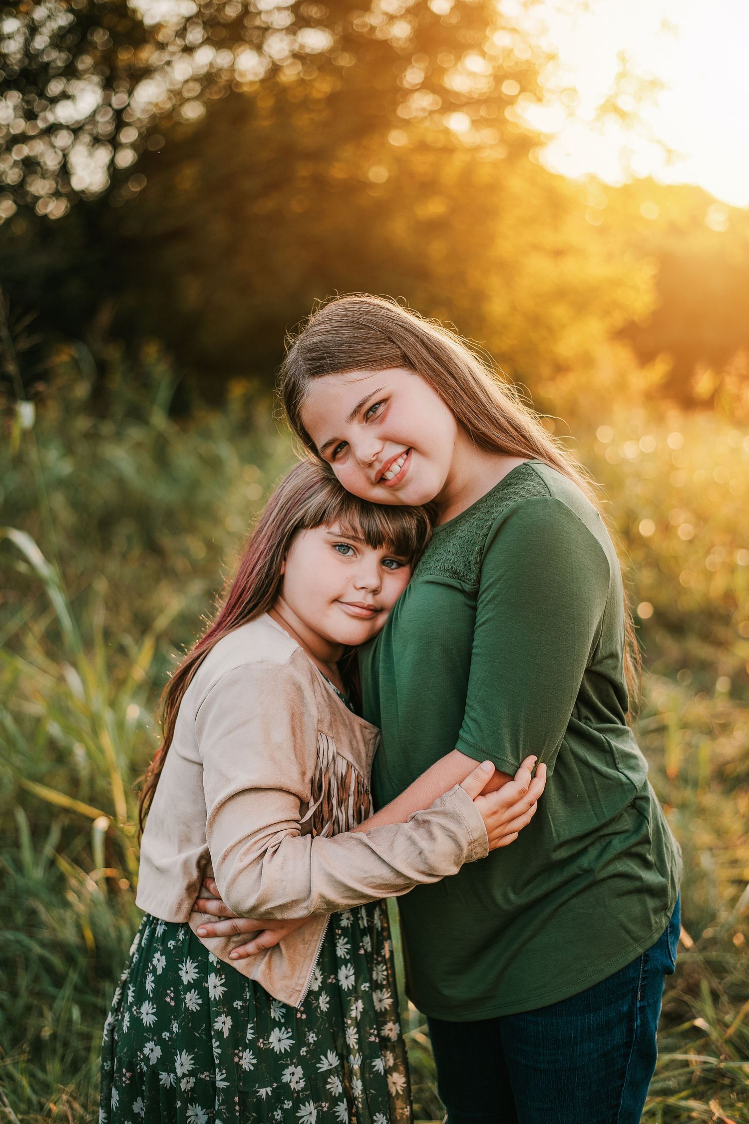 Warm sunset portrait in a field with natural golden lighting.
