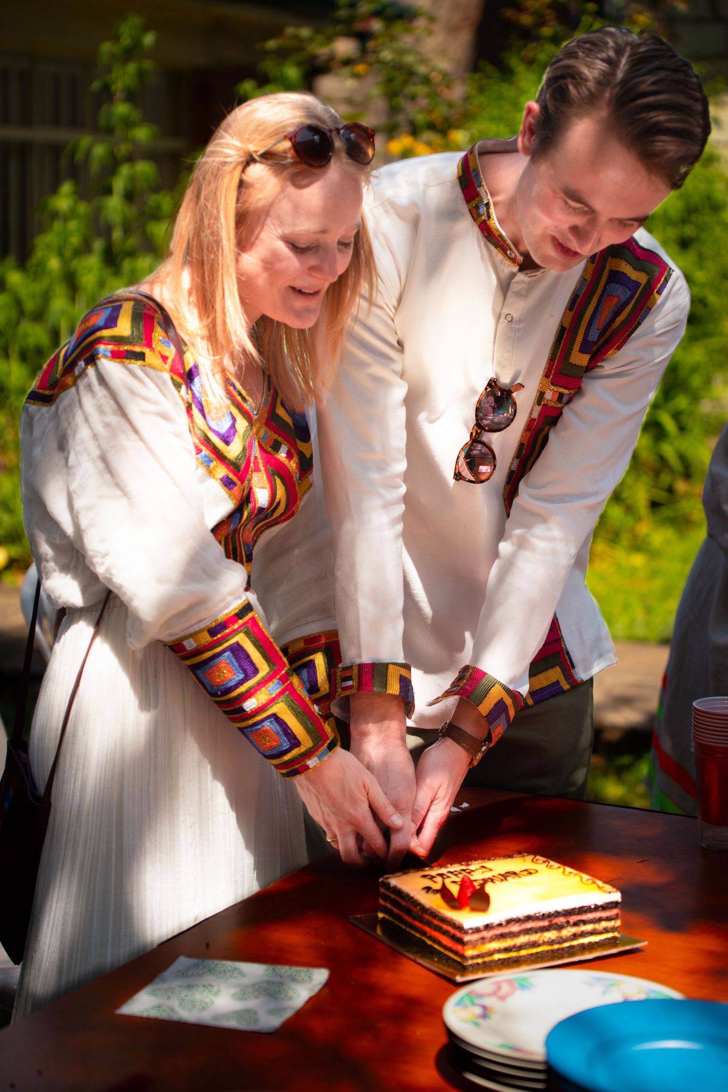 A couple cutting their cake at their destination wedding celebration in Addis Ababa.