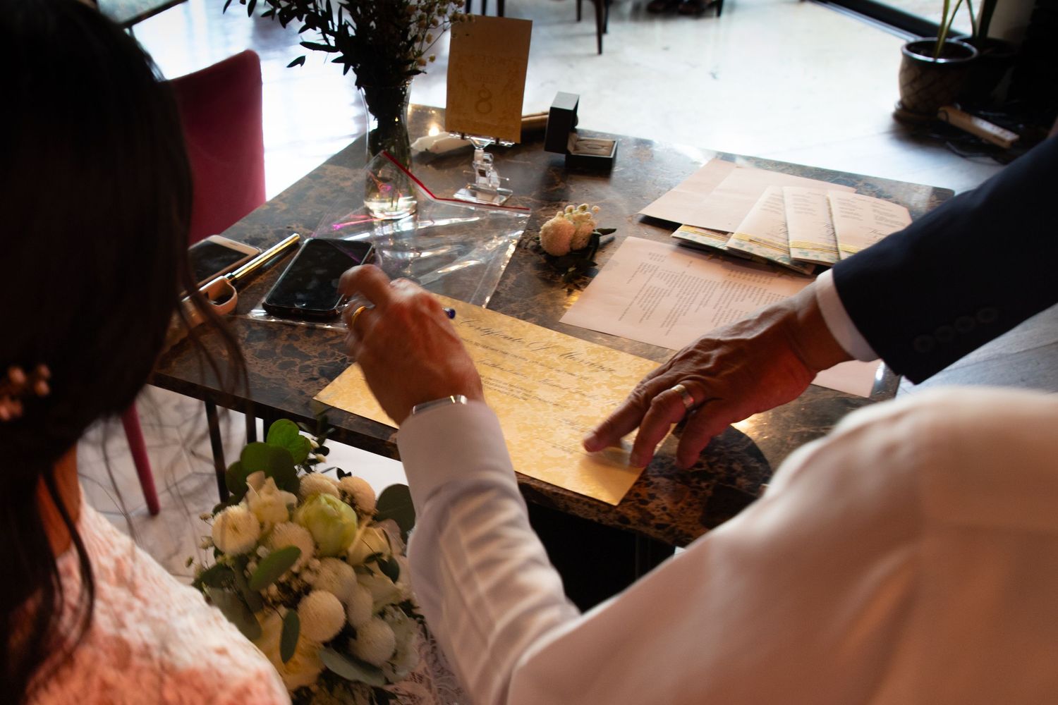A couple signing their license at their destination wedding on Koh Samui, Thailand.