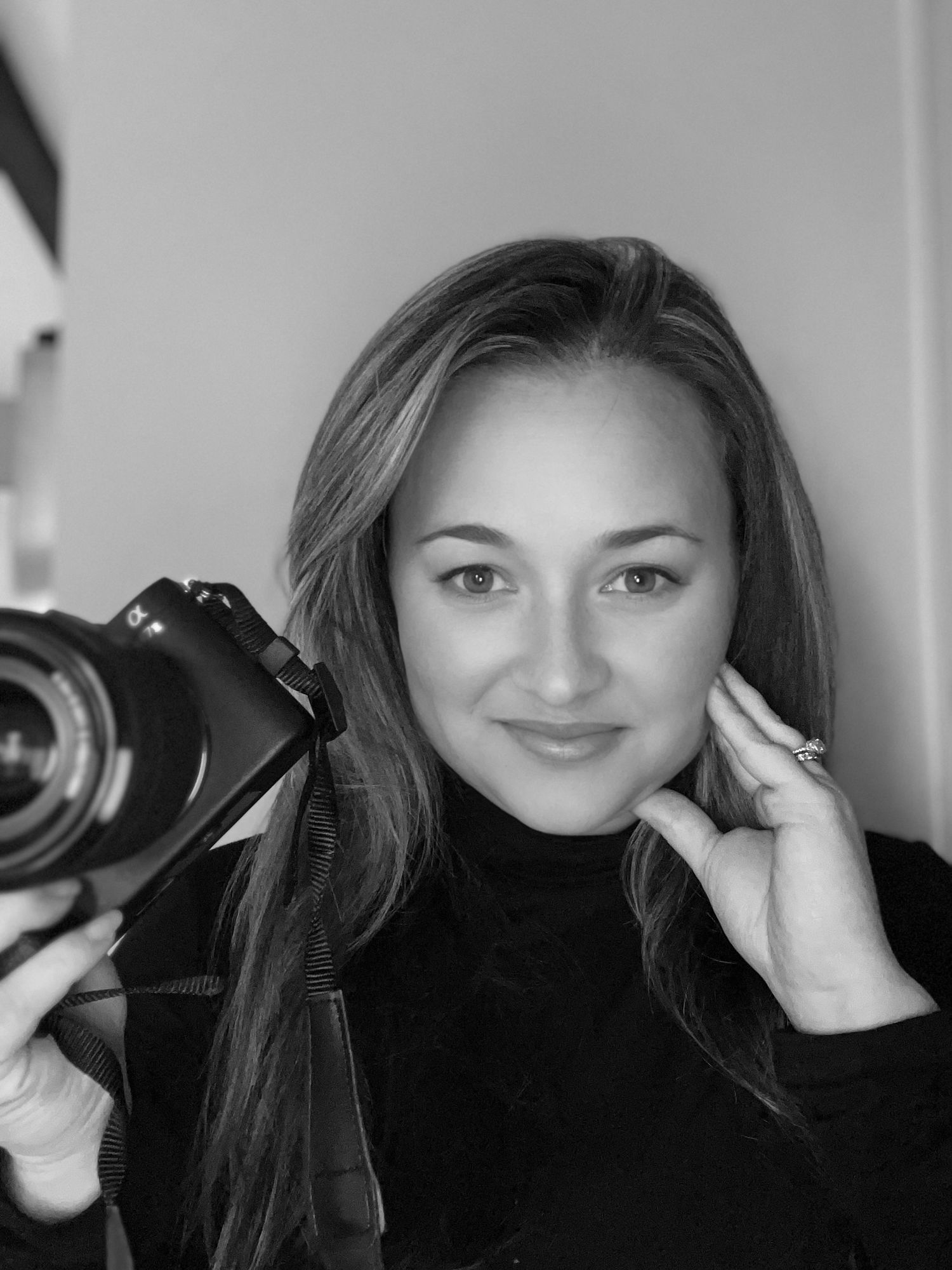 Photographer based in Rhode Island poses with her camera.