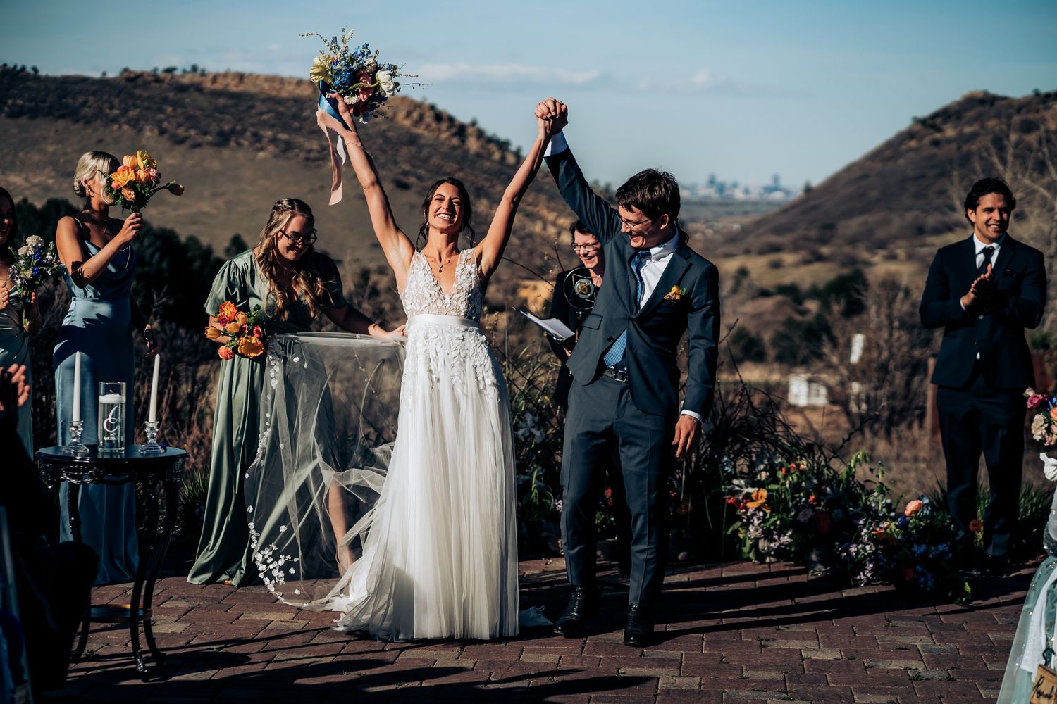Outdoor wedding ceremony with mountain views and guests gathered to celebrate.