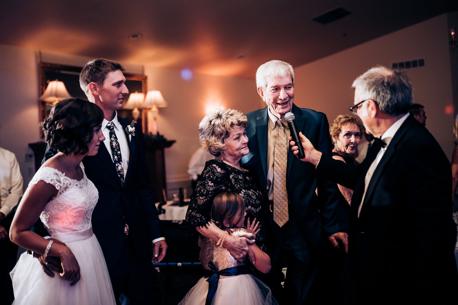 Wedding guests gather for a celebratory moment during the reception.