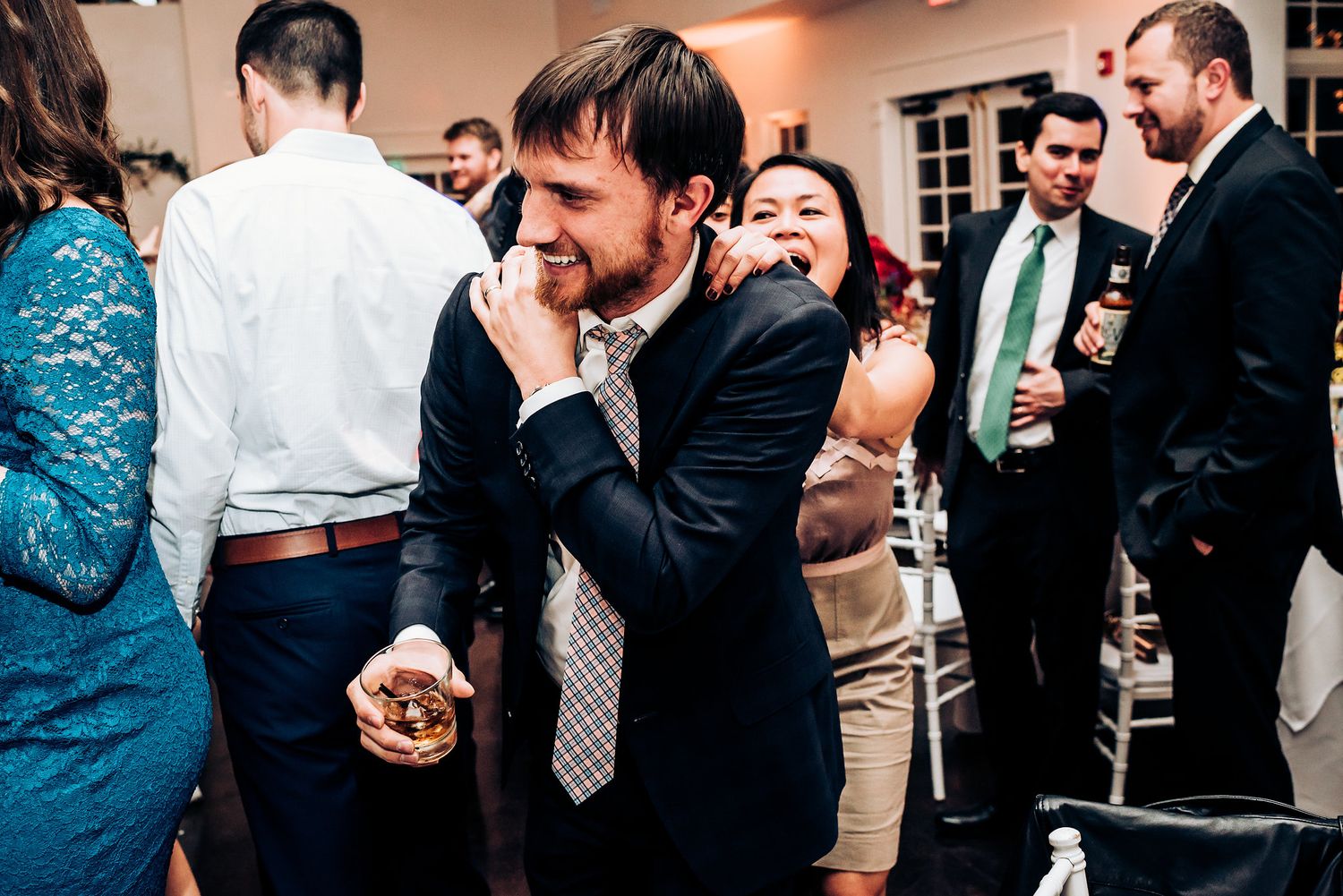 Guests share laughs and dance moves during an energetic wedding celebration.