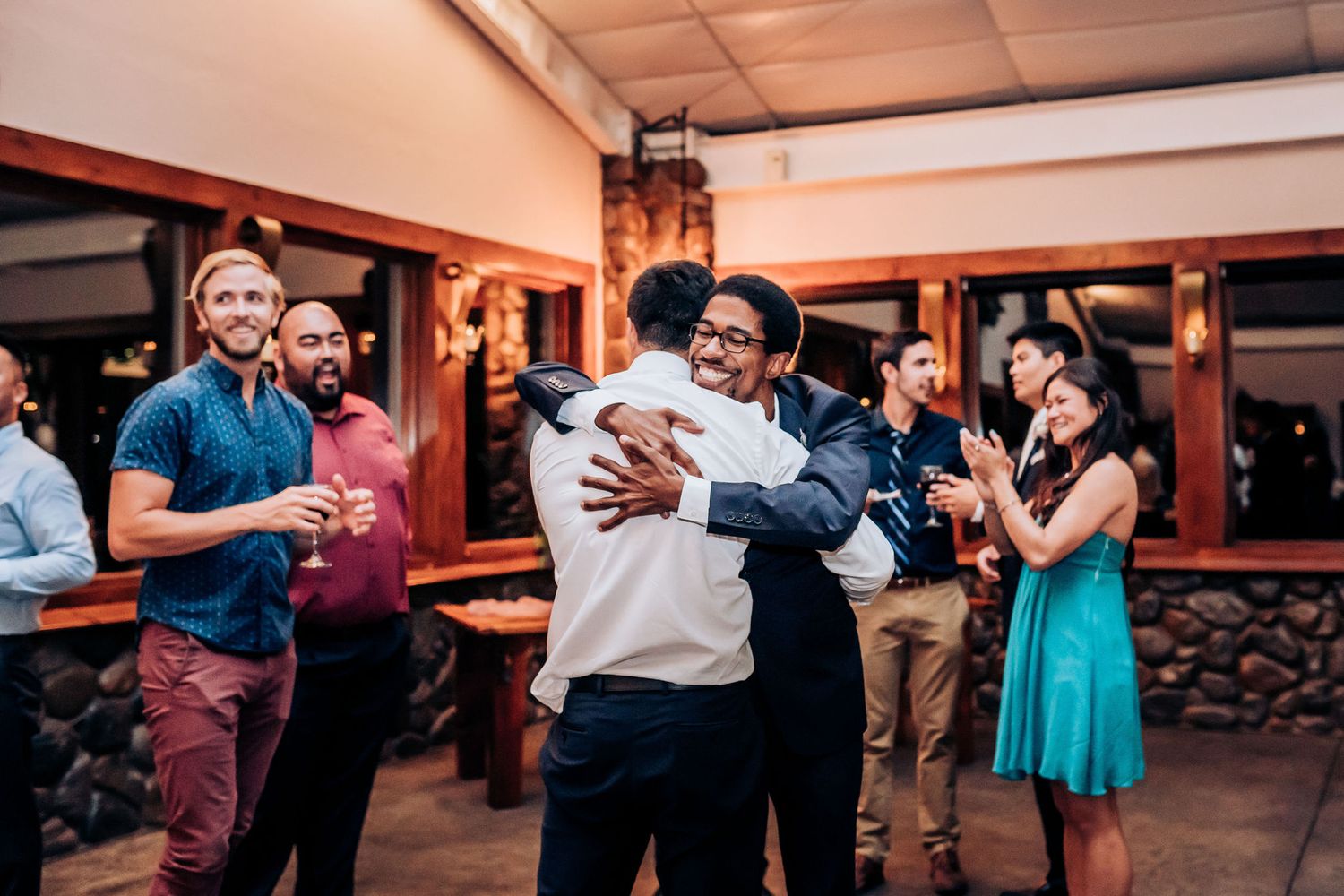 Guests embracing and celebrating during a joyful moment at the wedding reception.