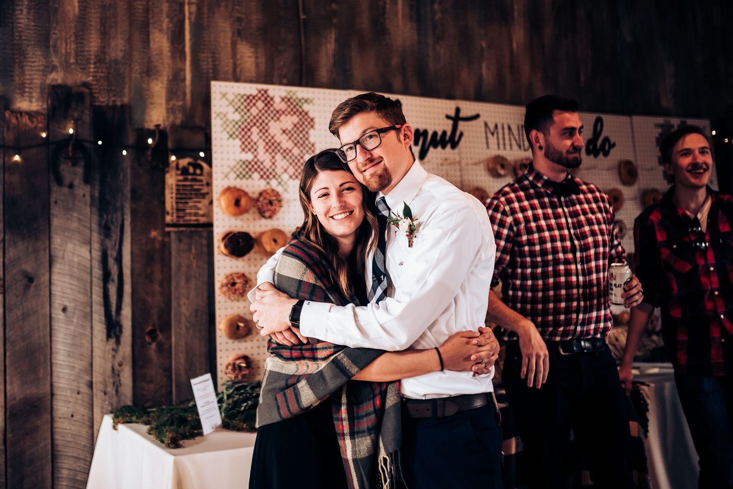 Rustic indoor celebration with string lights and wooden wall decorations.