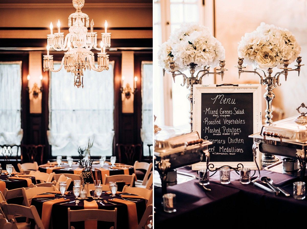 Elegant wedding reception venue with crystal chandeliers and tables set with copper and black decor.
