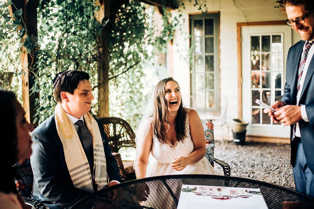 Wedding celebration candid moment on outdoor patio with natural lighting.
