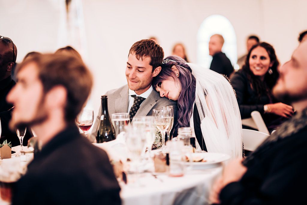 Guests enjoy an intimate reception dinner under warm lighting at a wedding celebration.