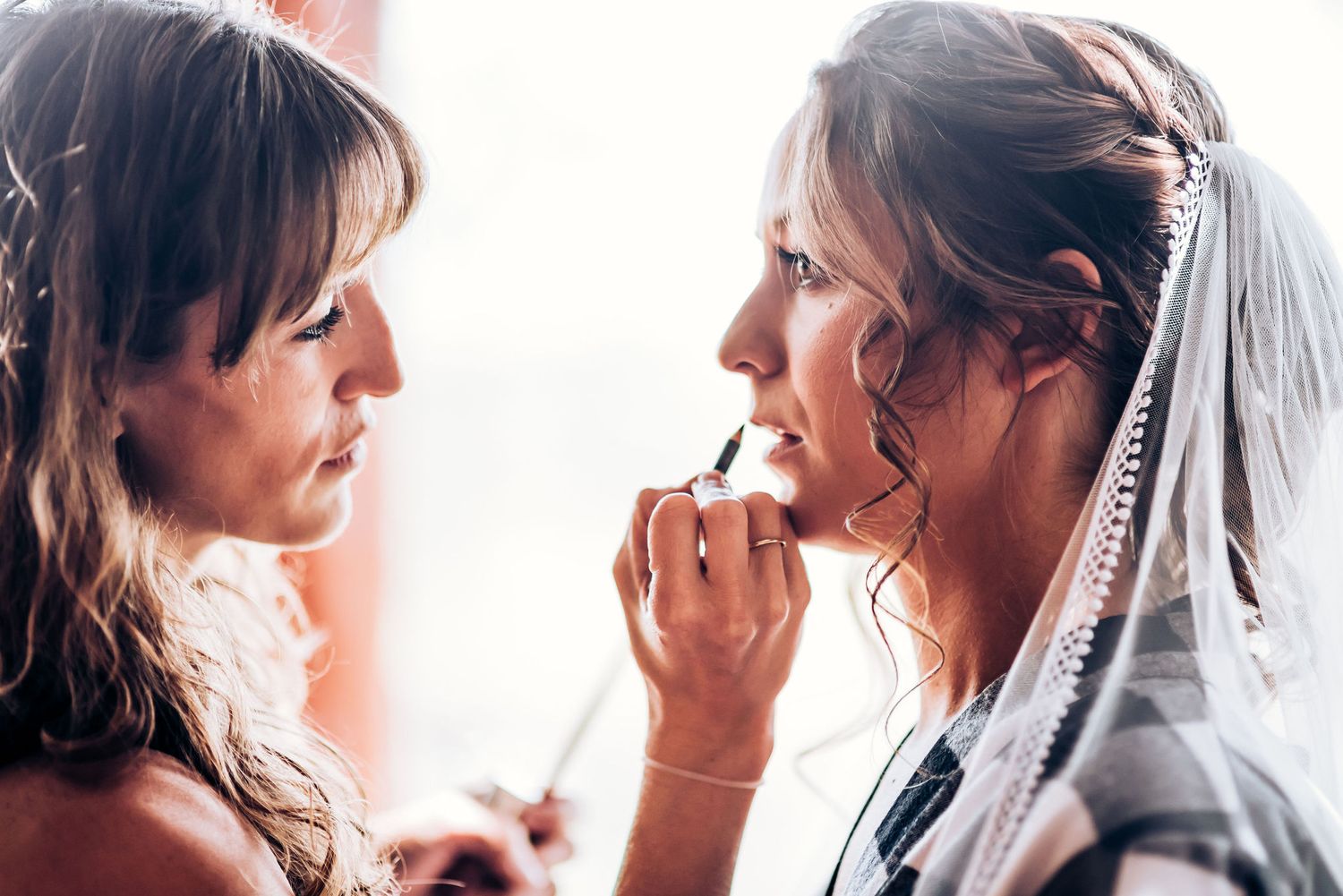 Final makeup touches being applied during bridal preparation.